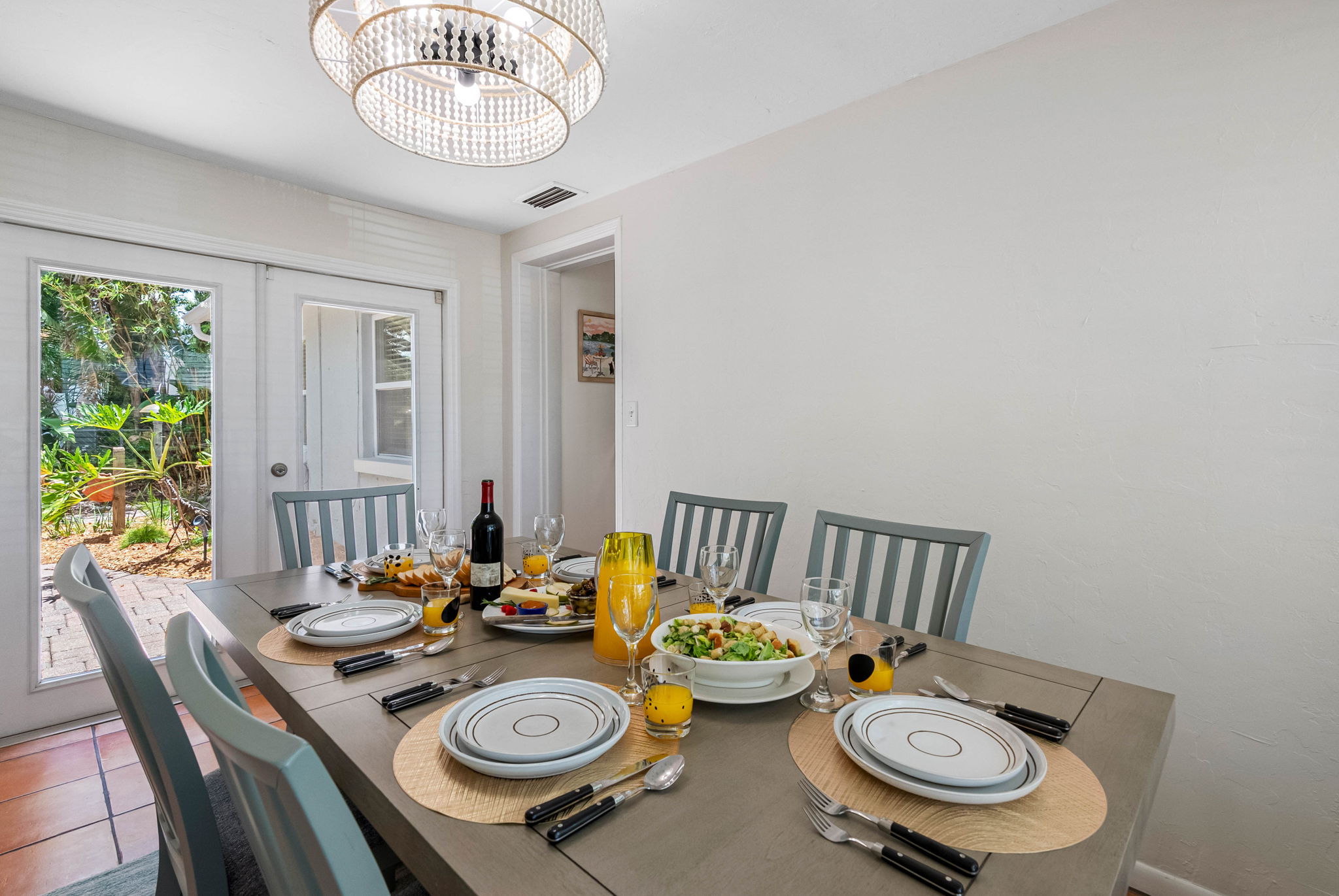 Framed by a large picture window, the space is bathed in natural light, creating an airy, open feel throughout the day.