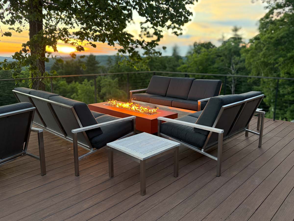 Fire table on the deck at Sunset Falls &mdash; evening gathering with the Berkshires valley beyond