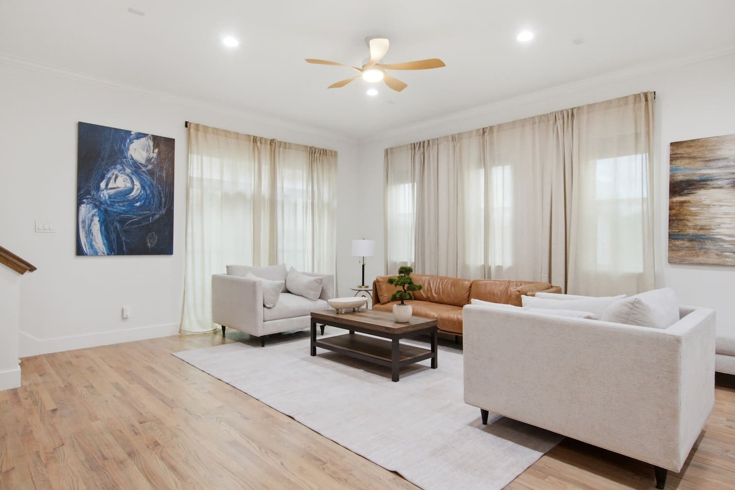 Living area with Smart TV, ceiling fan, and modern sectional seating. A comfortable space to decompress, catch up on a show, or regroup before the next outing in Dallas.
