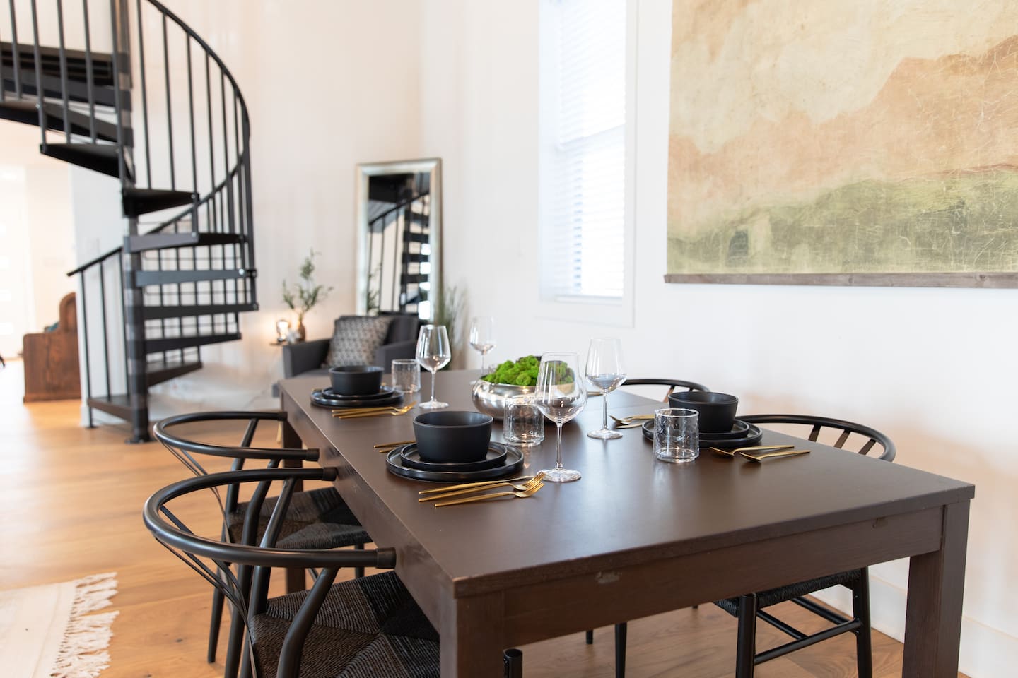 Charming dining area located beside the stairs, creating a cozy and functional space for meals while adding a unique architectural touch to the home.