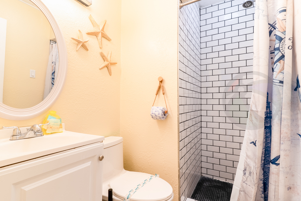 Between these 2 bedrooms - across from living room is restroom with shower
