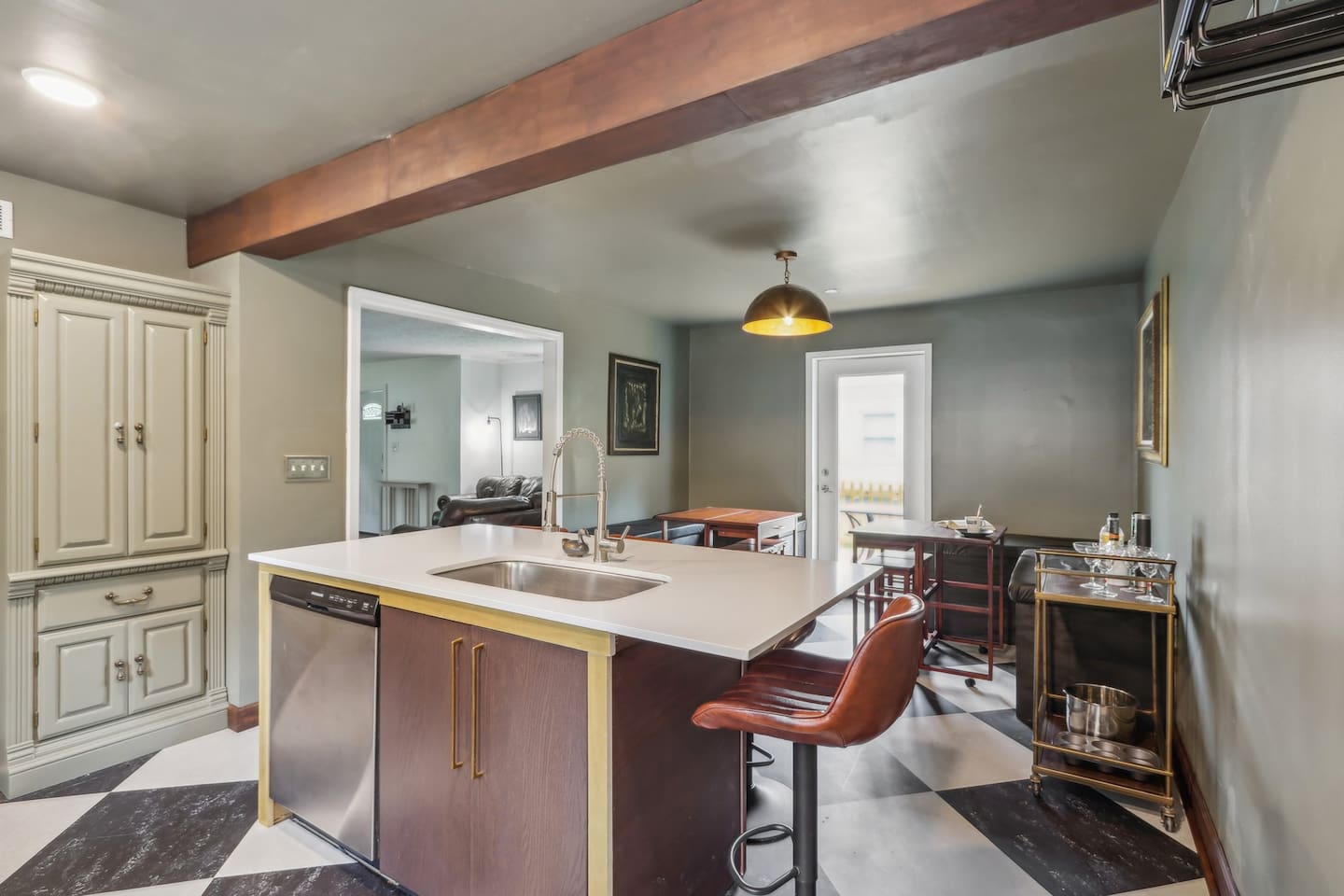 Gather around the kitchen island for coffee or quick bites, with bar seating and an easy flow into the adjoining lounge area.