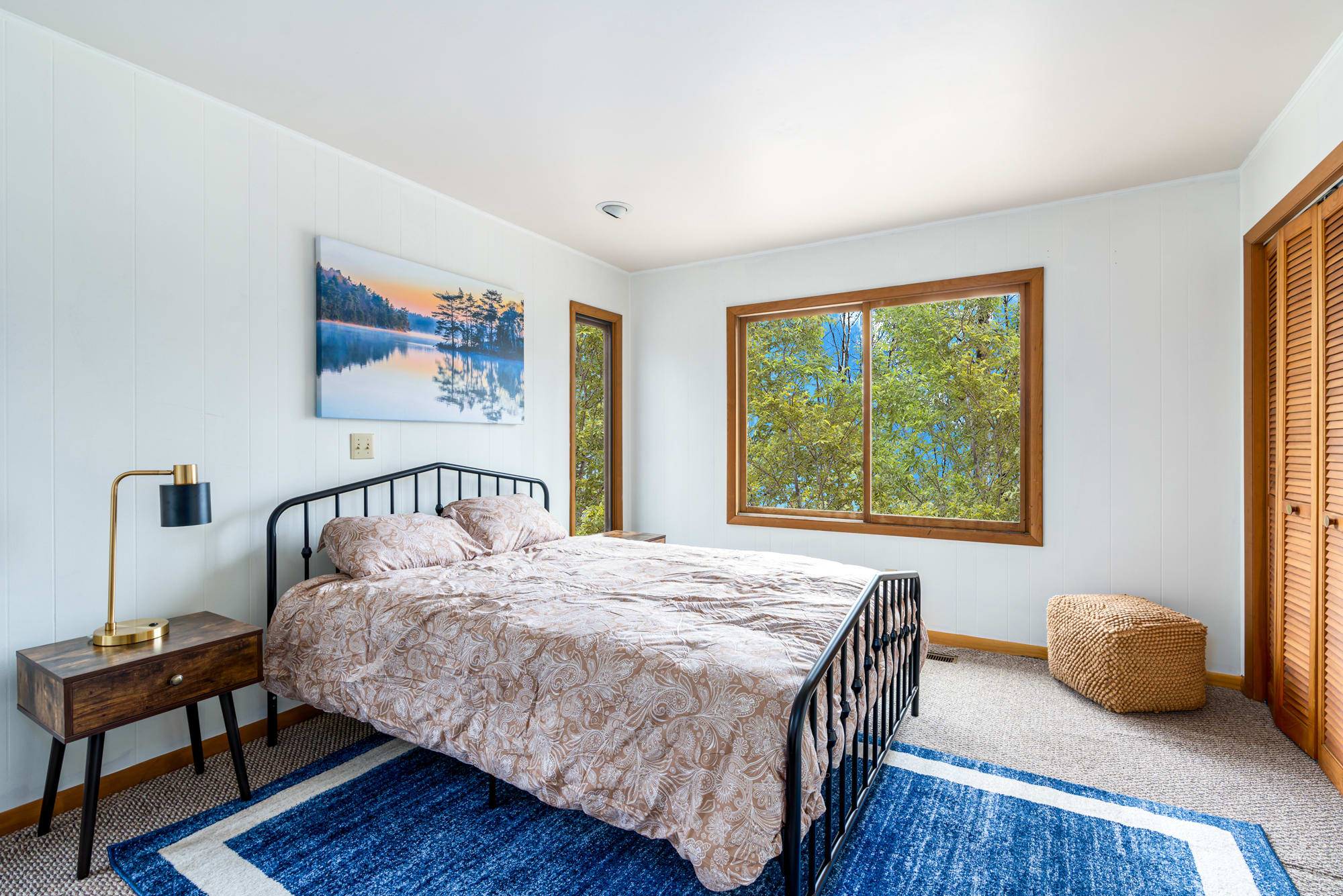 This bedroom has a Queen bed. All the bedrooms will be upgraded with fresh paint and beautiful linens. Wake up with views of the surrounding woods.