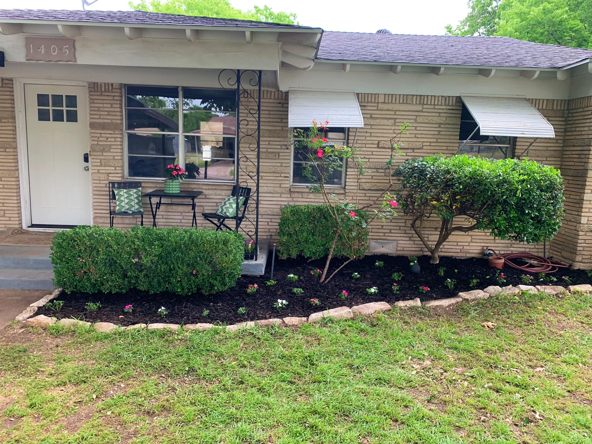 Cutest front porch and fresh flower beds