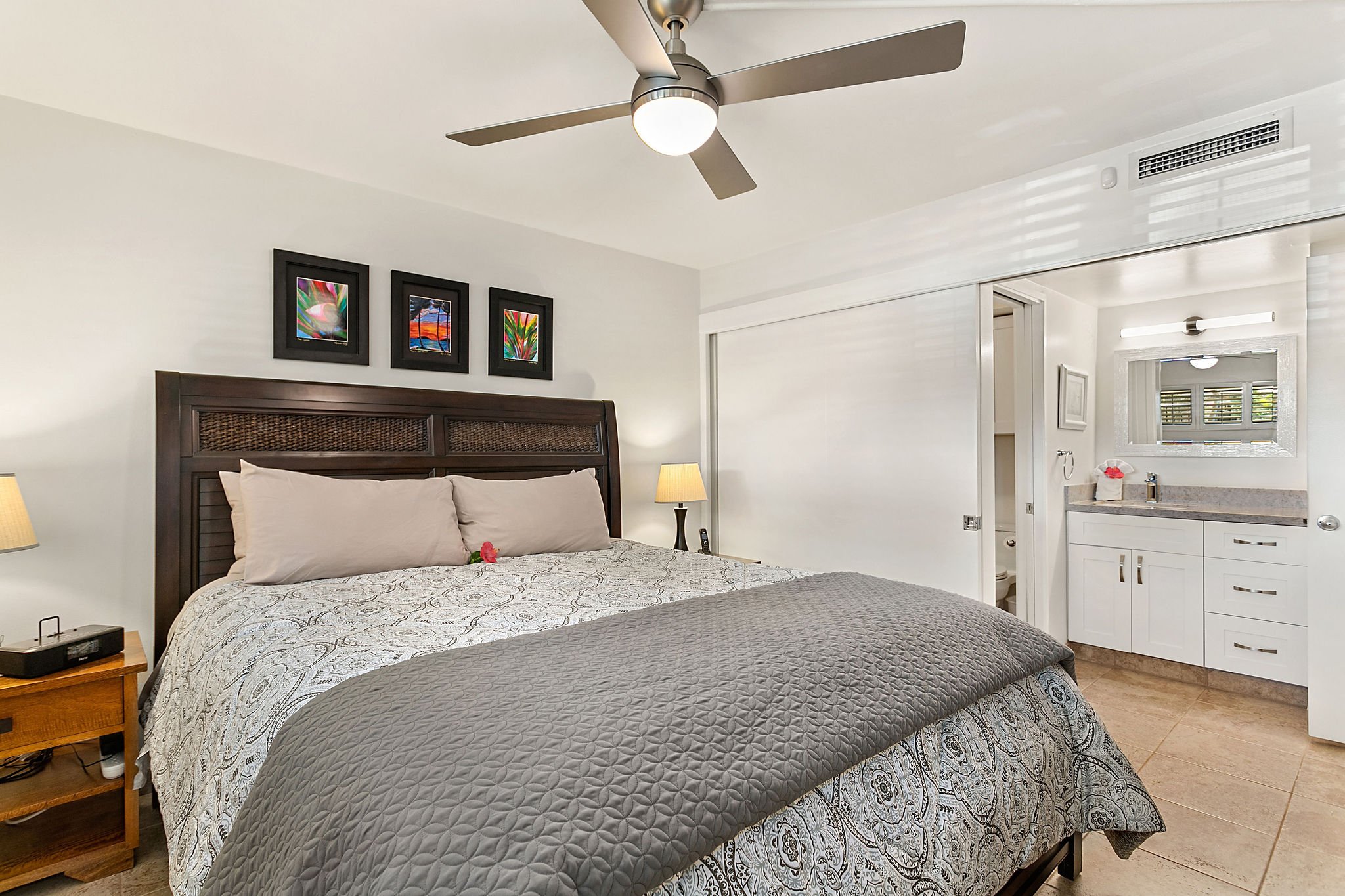 The bedroom is separated from the vanity area by a large sliding door