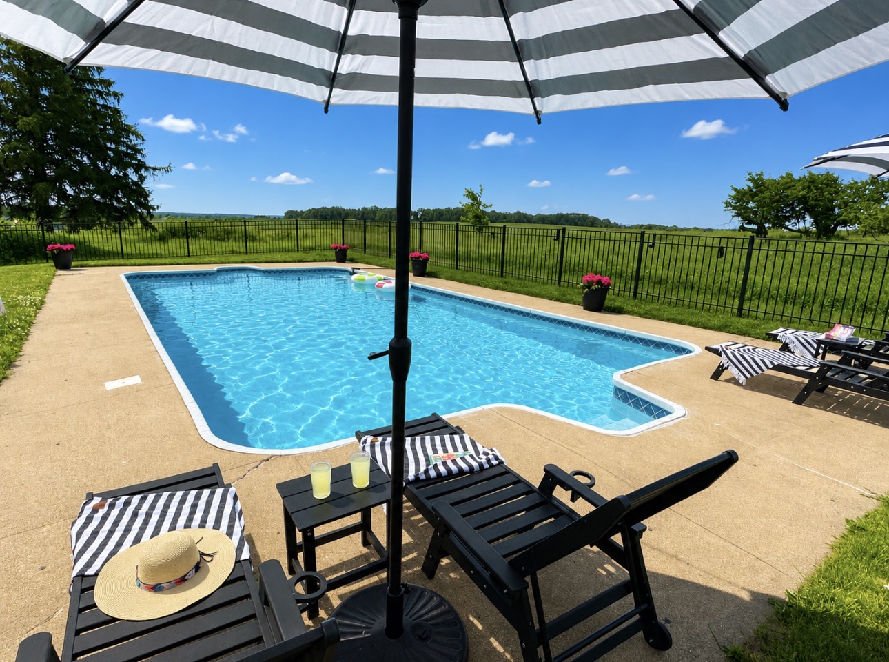 Your private pool oasis awaits! Lounge under striped umbrellas, cool off in the sparkling pool, gather around the fire pit, and soak in peaceful orchard views. The perfect backdrop for family vacations, friend getaways, and summer memories.