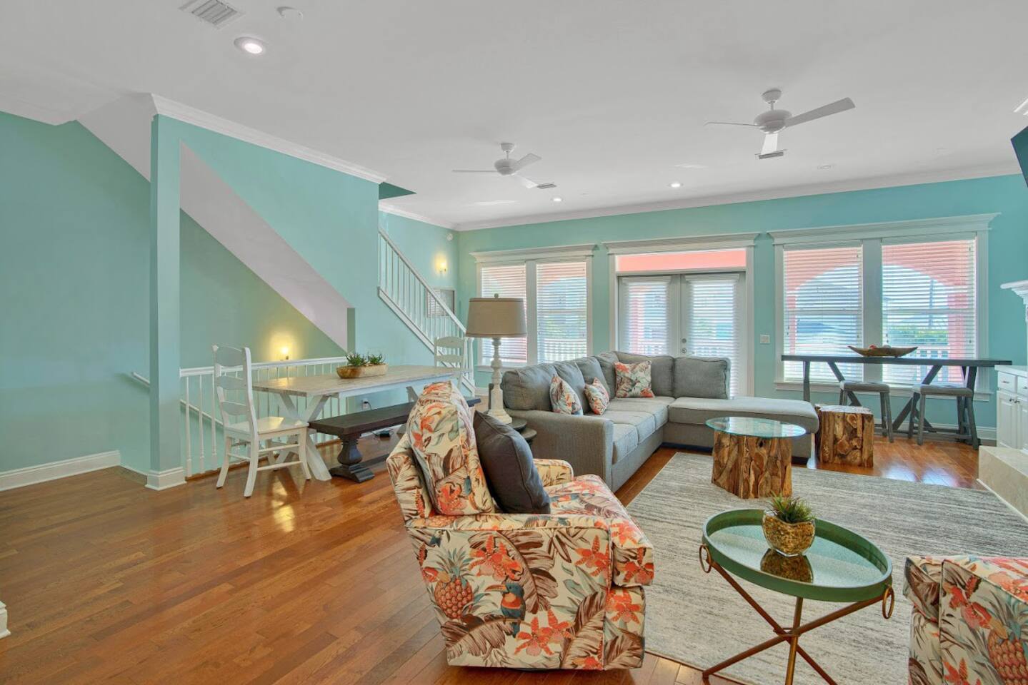 Second floor living and dining area with stairs from first floor and two second floor at the back.