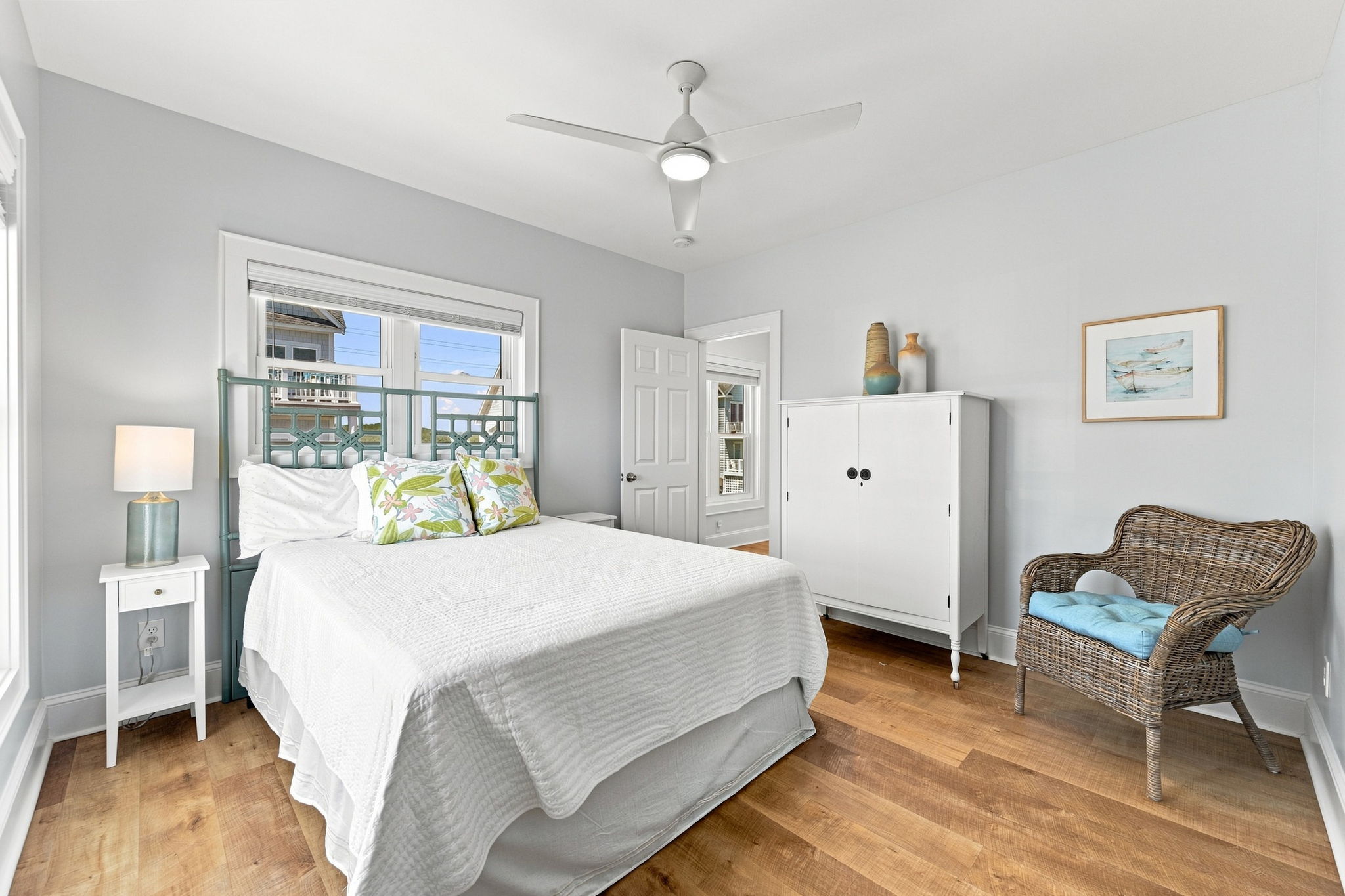 A comfortable guest room offering privacy, convenience, and modern touches including a Smart TV and ceiling fan.