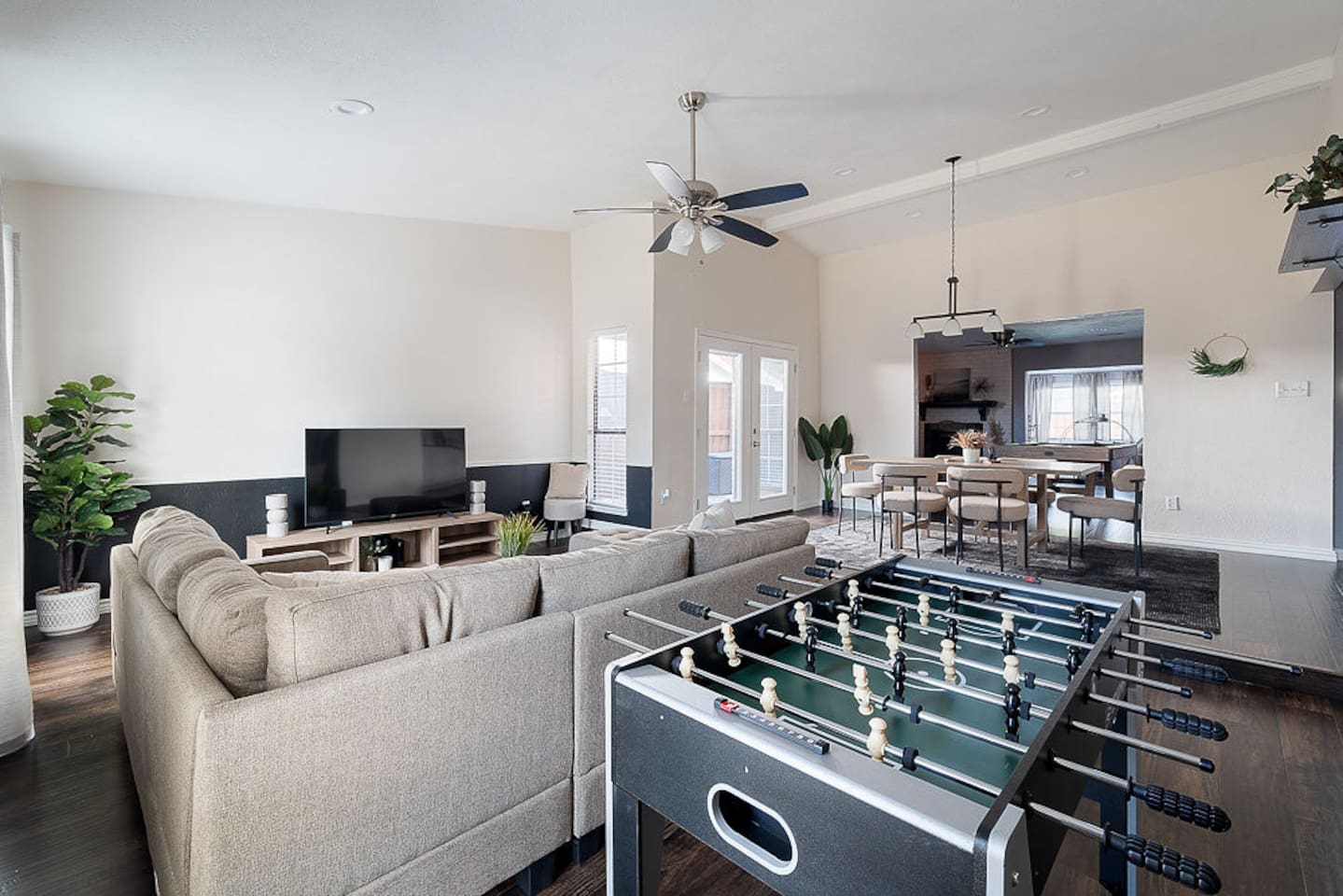 Relax on the comfortable couch next to the 65" HDTV or stand for a game of foosball