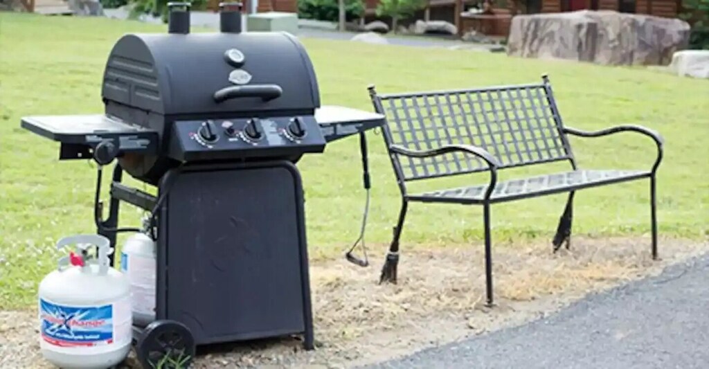 There is a shared community grill approximately 100 feet away from the rear of the cabin.