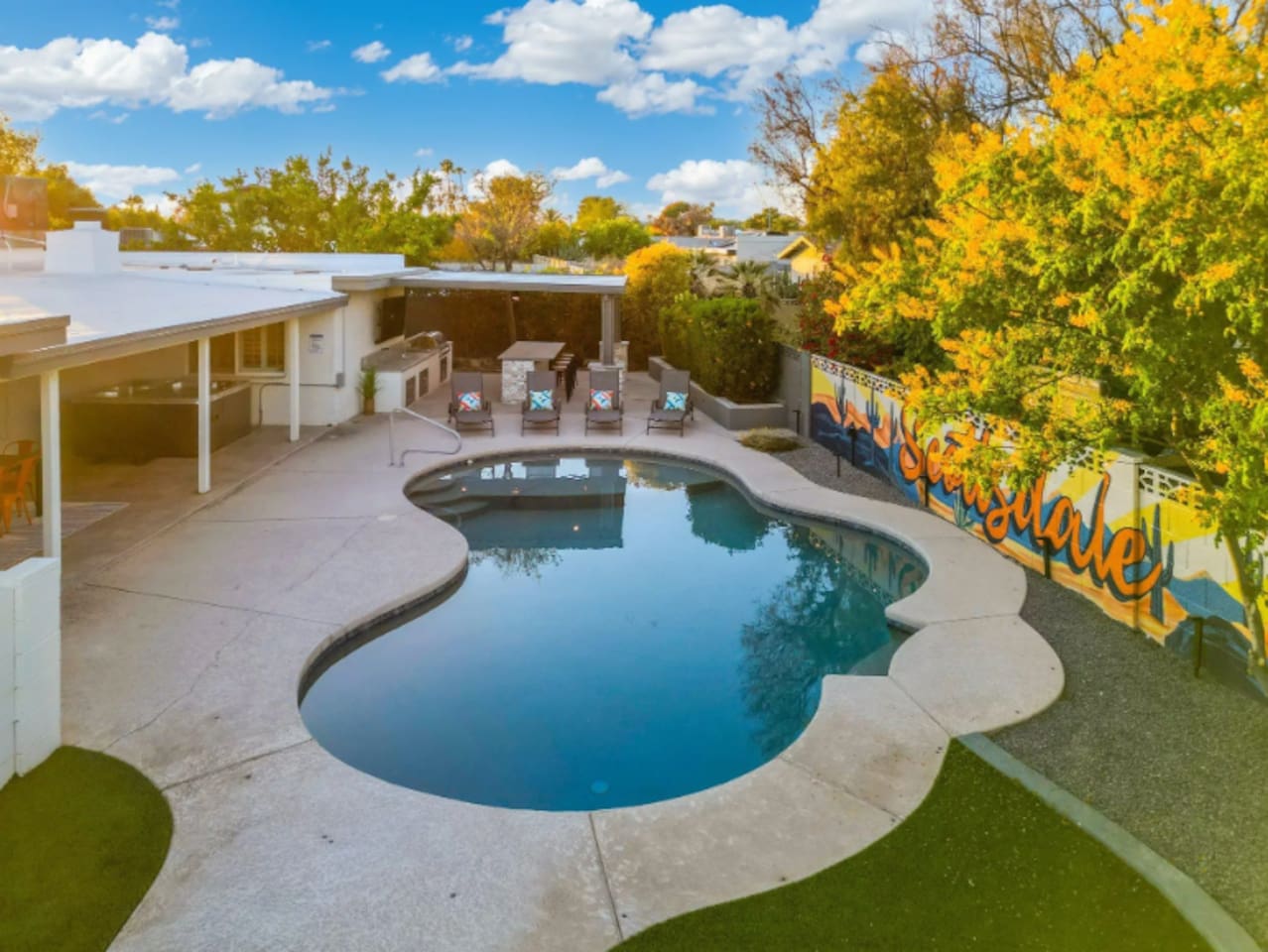 From above, the pool's curved shape and shaded patio come together into one seamless outdoor living space.
