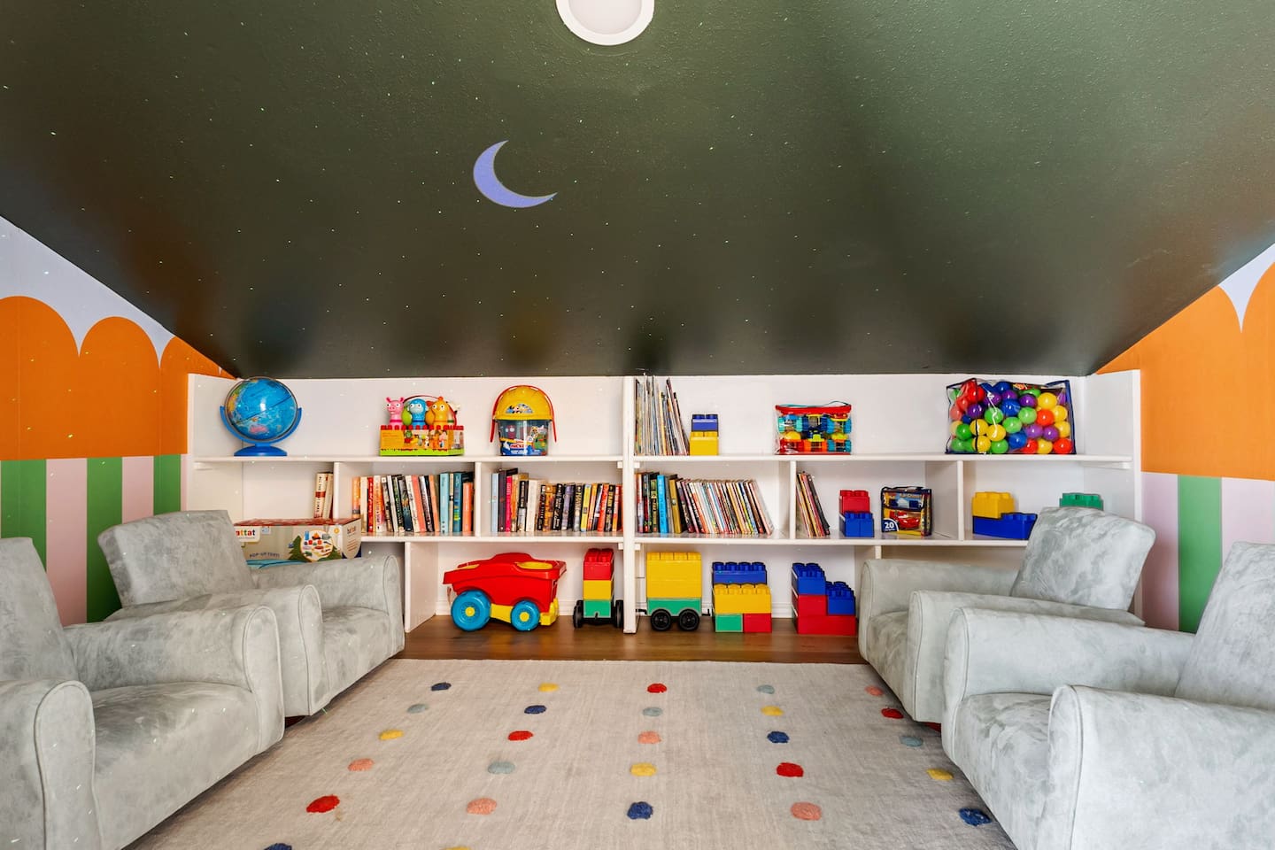 Where imagination blasts off!   
Our kids' playroom is stocked with books, toys, and cozy chairs under a starry sky ceiling—perfect for little adventurers to read, build, and dream big.