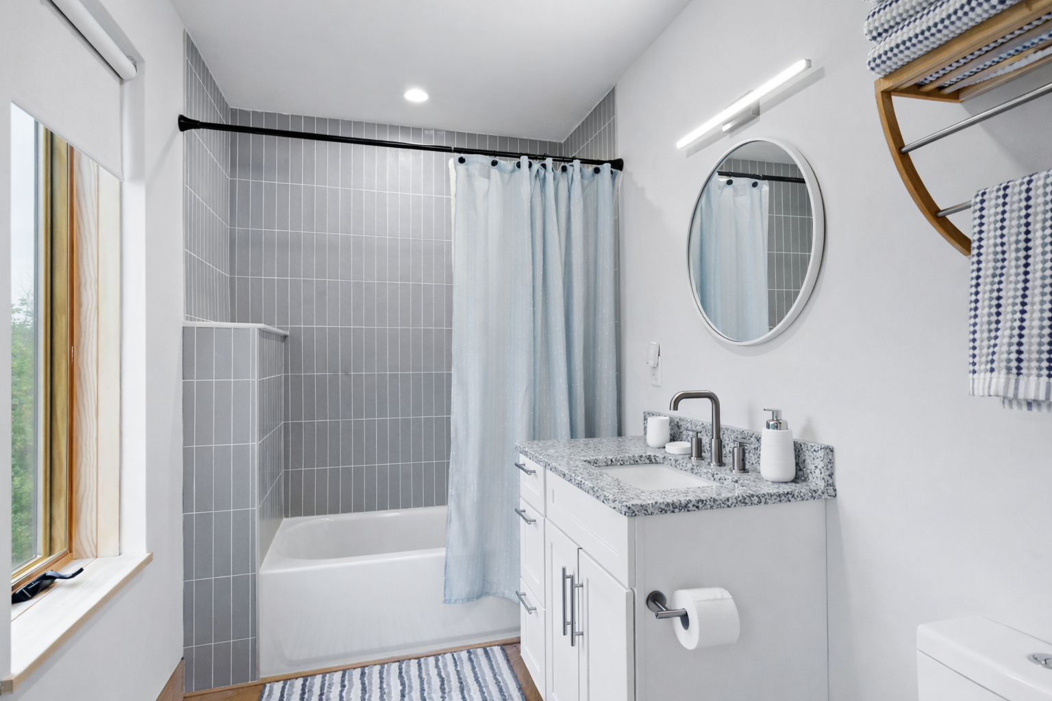 The full bathroom on the second floor is tucked away on the backside of the open concept living room and kitchen for privacy