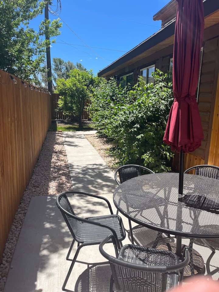 Outside backyard leading to hot tub.