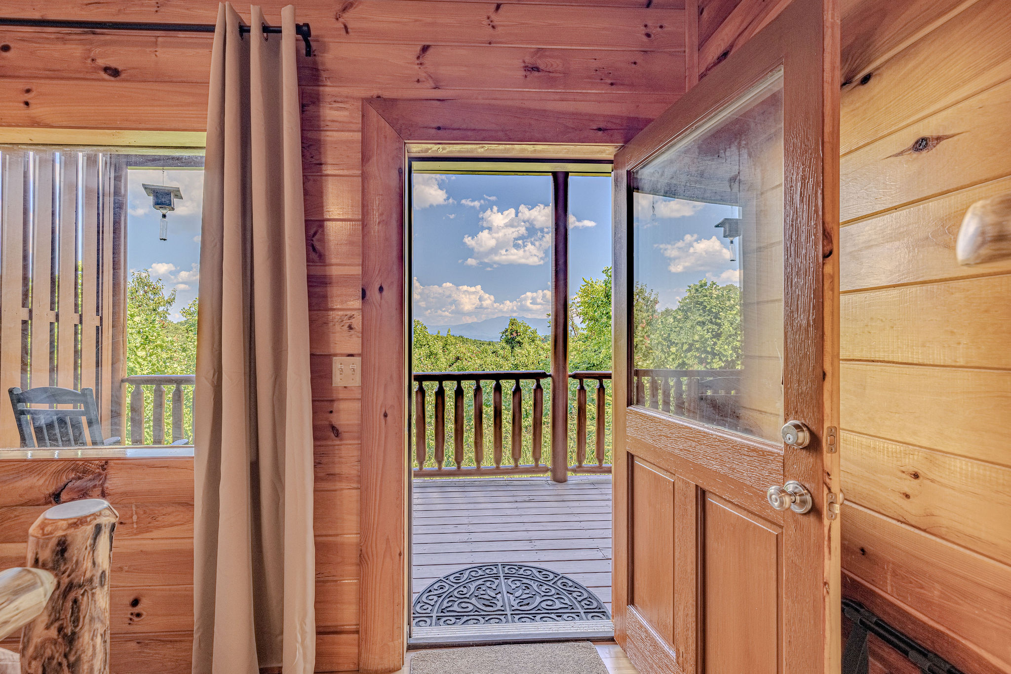 Your private escape awaits! From the comfort of your king suite, step onto the deck and find cozy seating, a relaxing hot tub, and the tranquility of the great outdoors.