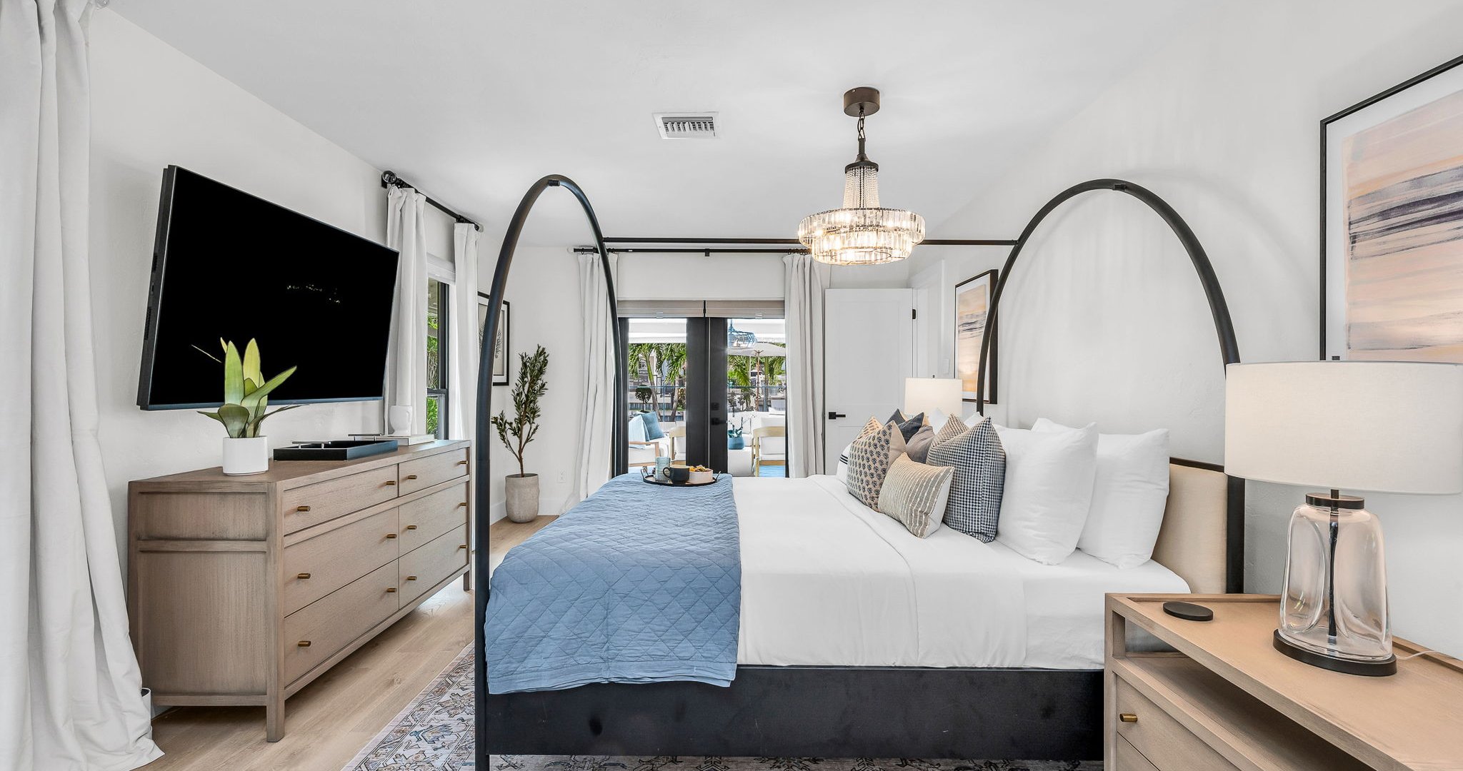 This second primary suite offers a plush king bed, private ensuite bathroom, and walk-in closet for added comfort. Enjoy poolside views and direct access to the outdoor living area, making it the perfect blend of luxury and convenience.