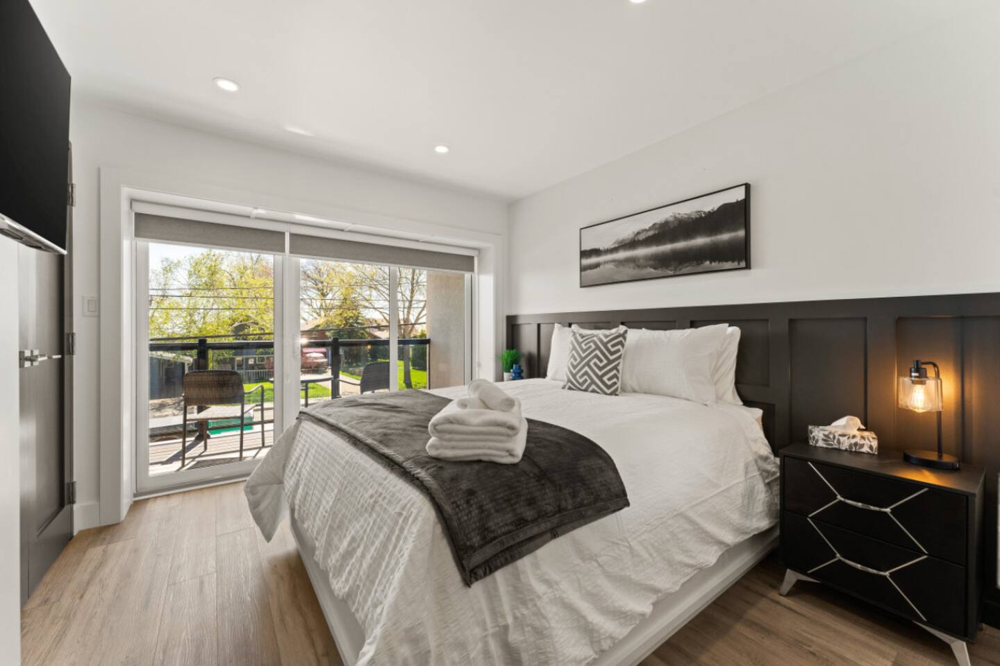 2nd floor Queen Bedroom with private balcony and modern minimalist design.