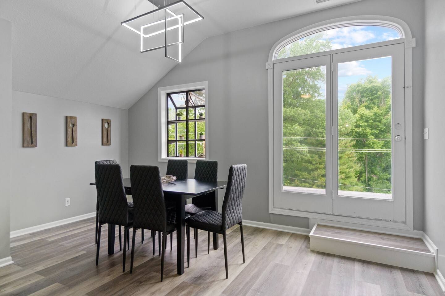 Elegant 6-seater dining area with a large window offering a beautiful nature view, perfect for enjoying meals in a tranquil setting.