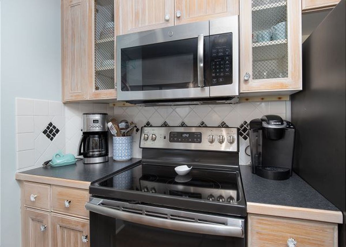 Kitchen range and microwave with Keurig and drip coffee maker on the counter