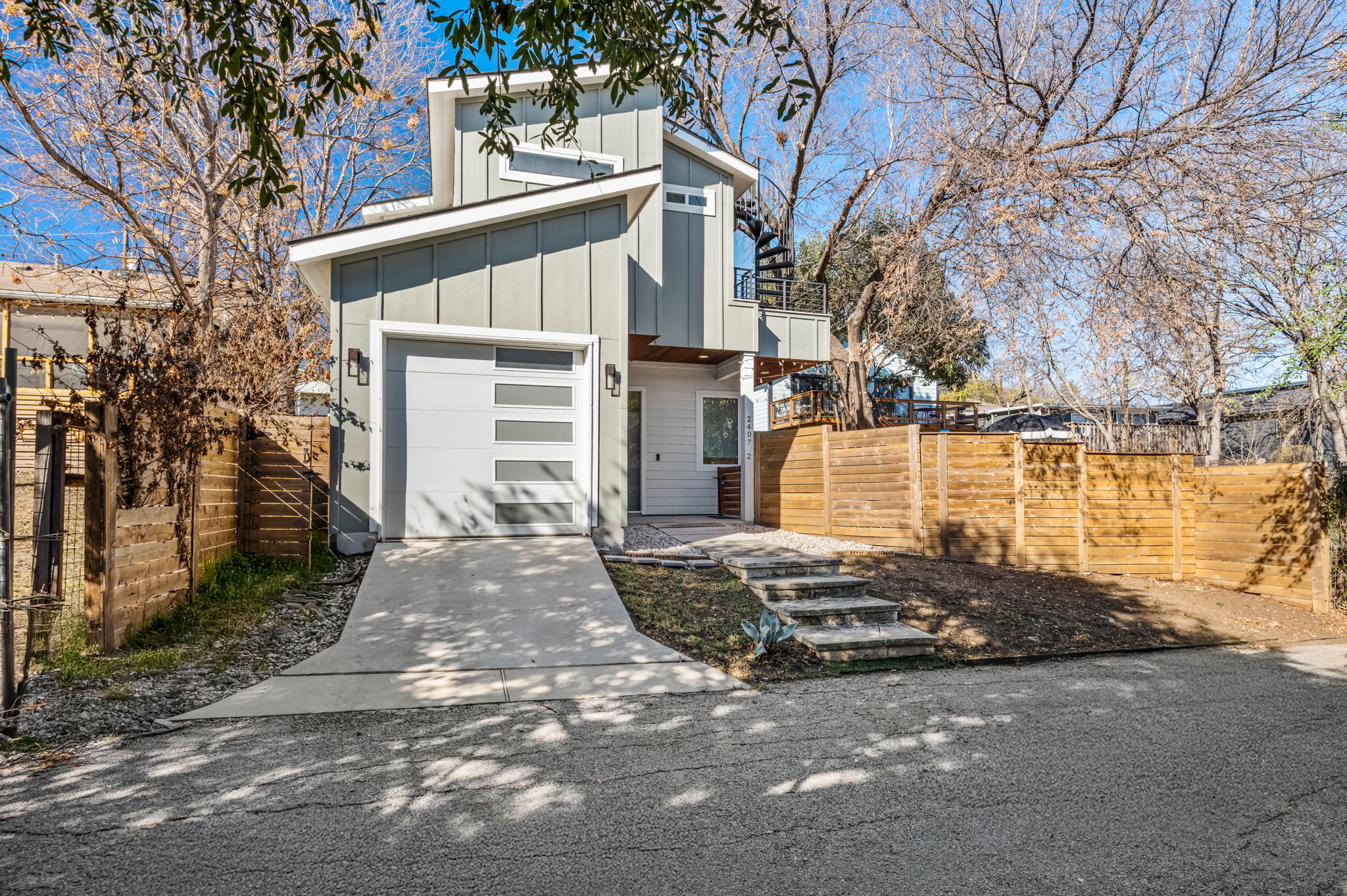 Modern exterior with private driveway and fenced yard