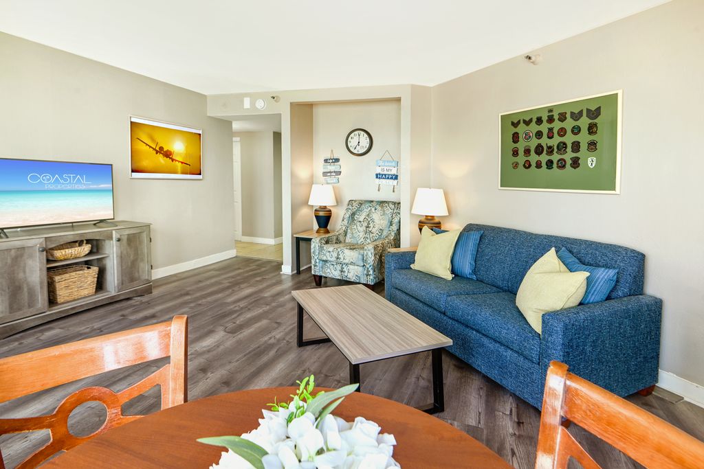 Find serenity in the living area of our oceanfront suite, where thoughtfully arranged furnishings create a tranquil space to relax by the sea.