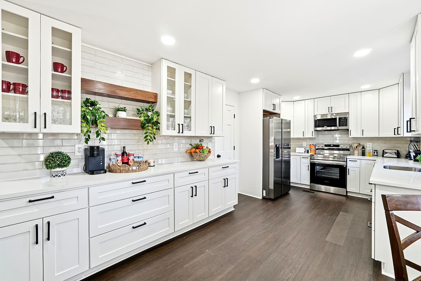 Bright white kitchen with a sleek, extended layout and ample counter space. The long layout offers plenty of countertop space, perfect for cooking, prepping, and everyday meals. Fully stocked with everything you need for a comfortable stay!
