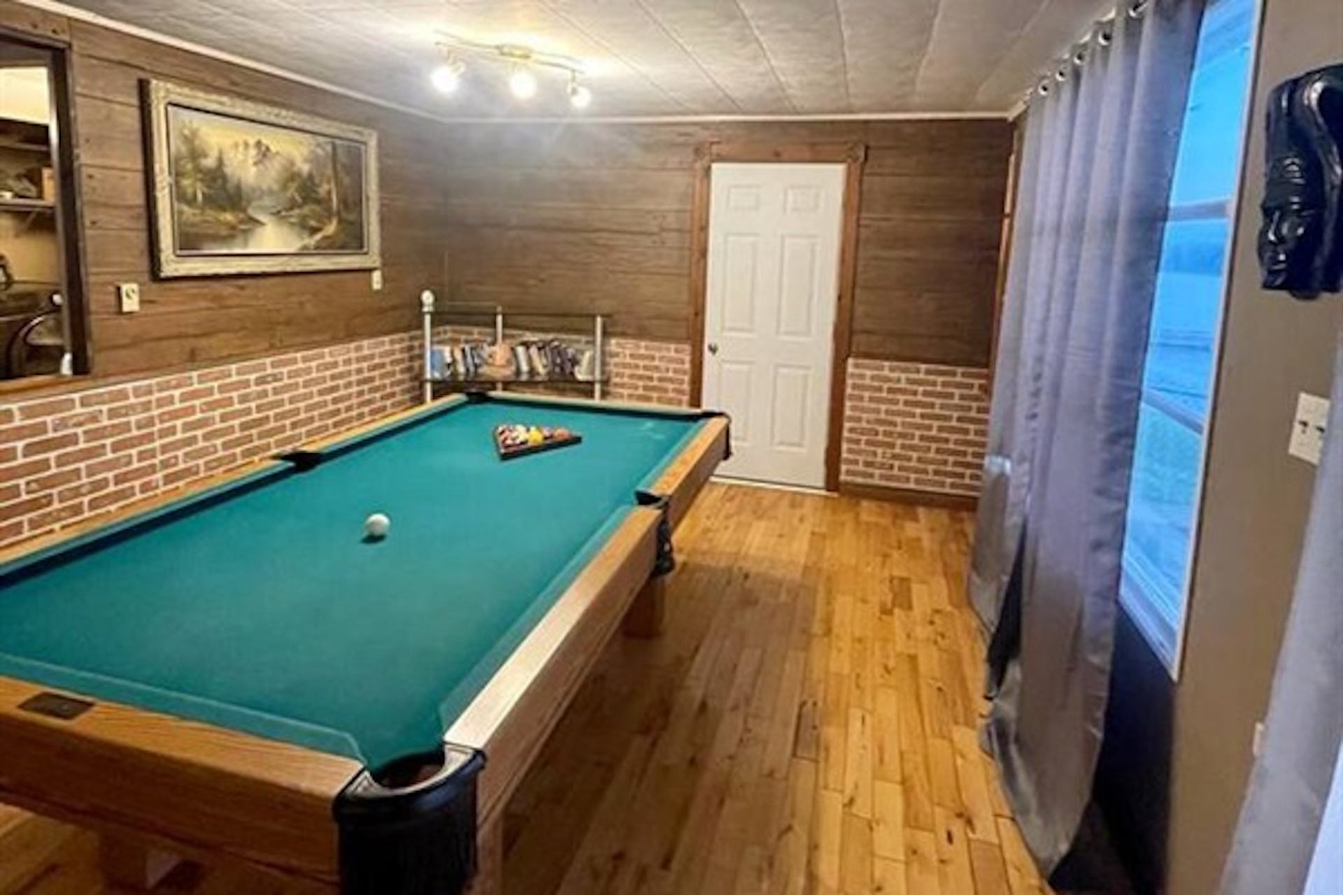 Recreation room with pool table and warm wood finishes