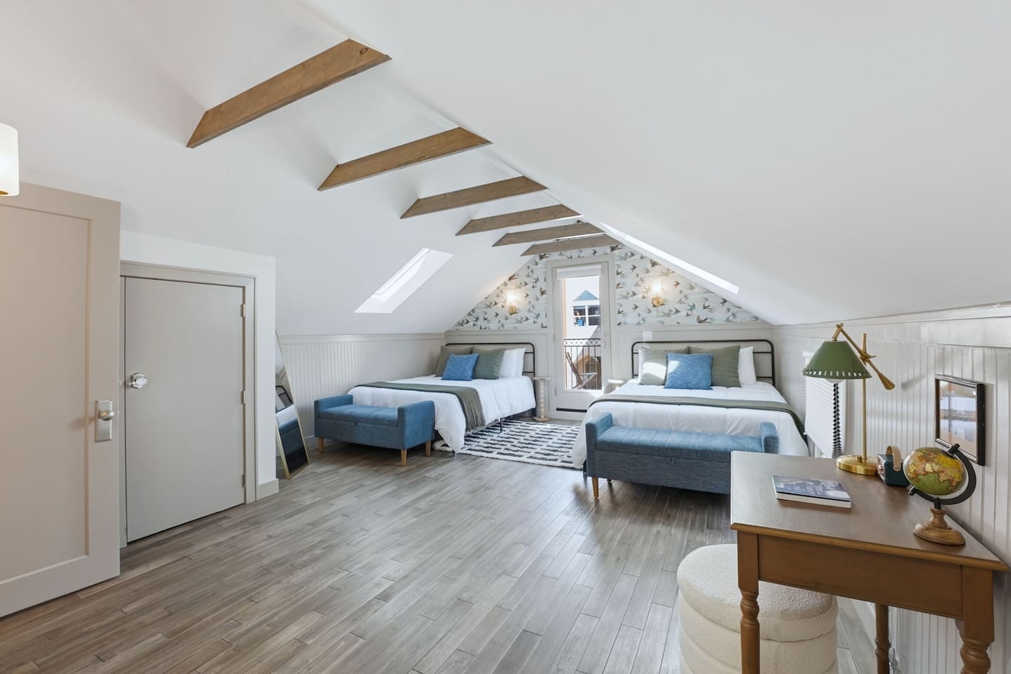 Bright and airy sleeping space with dual queen beds, skylights, and a dedicated workspace—perfect for families or groups.