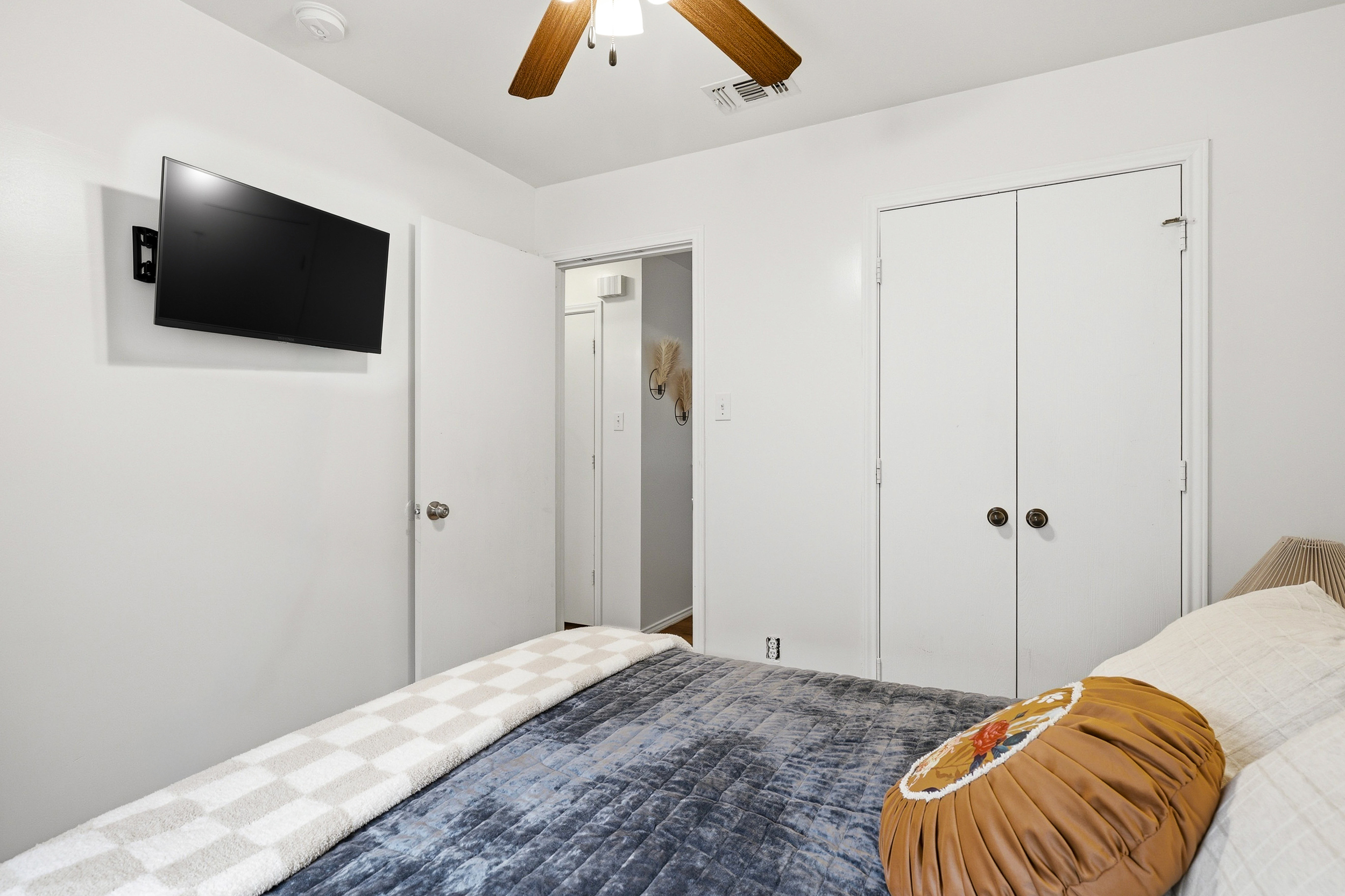 Queen bedroom with room darkening shades, plush bedding, and drawer space.