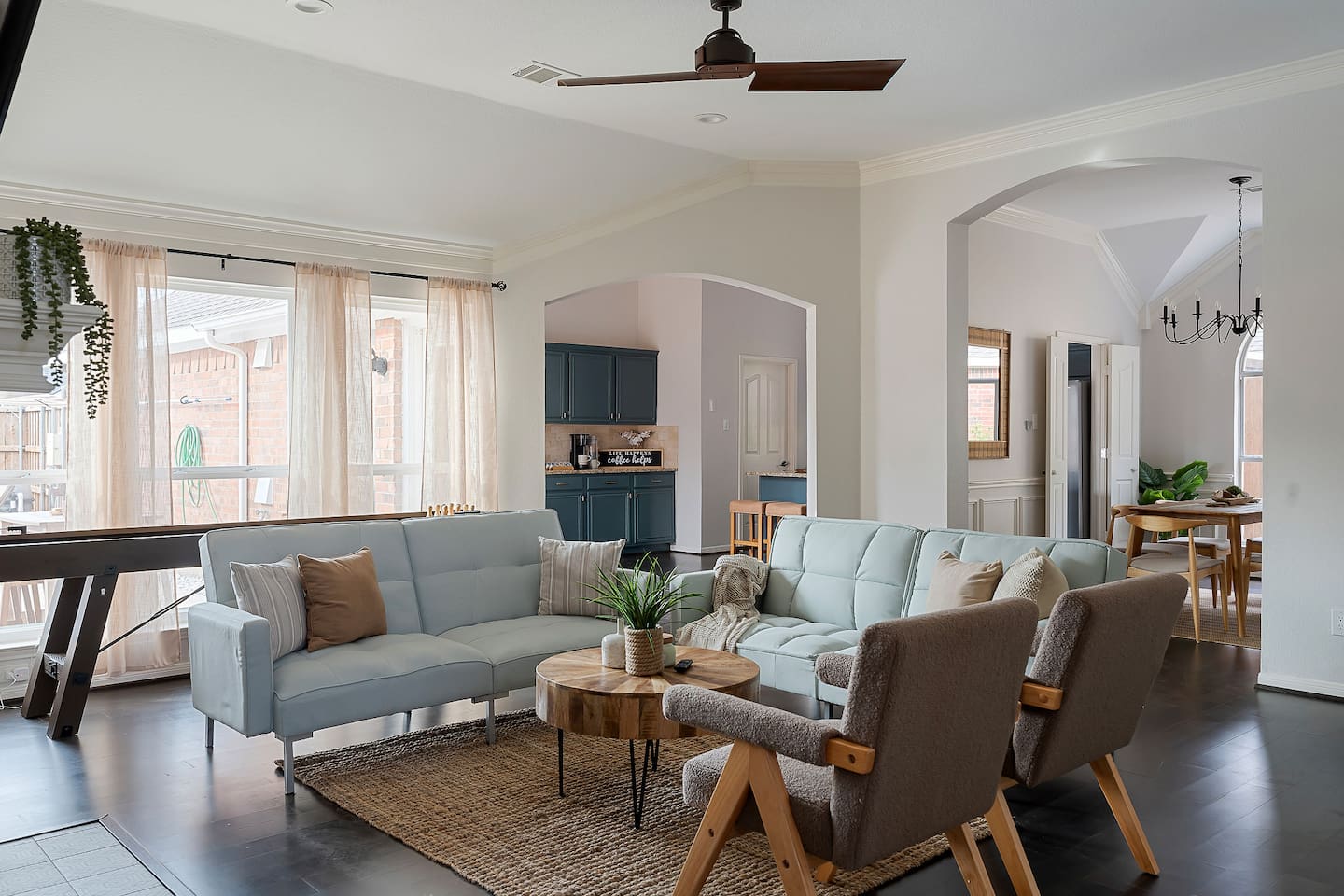 Welcome to our inviting living space with cozy sofas and a sleek TV setup. Shaded windows bring in just the right amount of natural light, creating a perfect balance of comfort and ambiance.