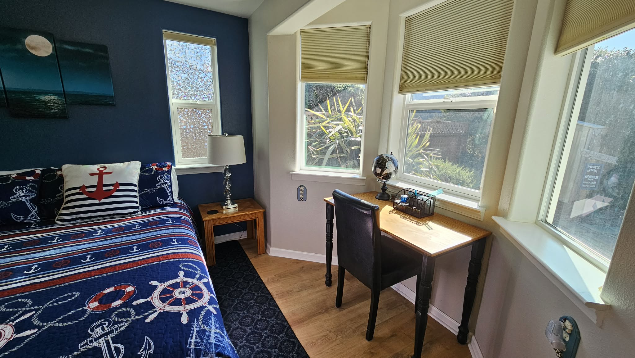 Desk in primary bedroom that looks onto backyard garden