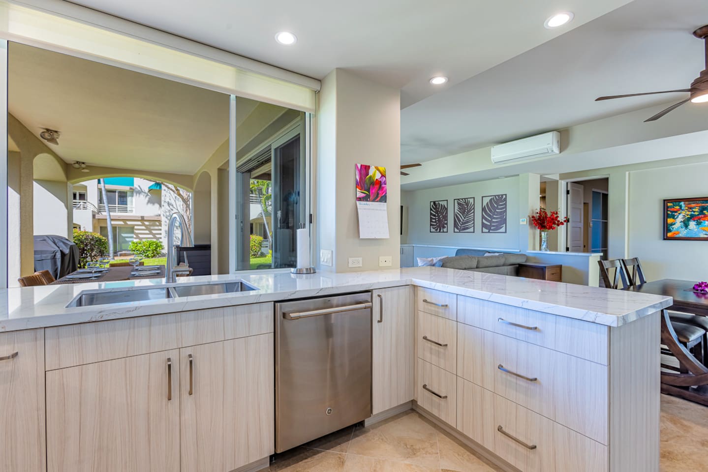 The large modern kitchen has a handy pass-thru window to the lanai. Note the BBQ was removed May 2024. There are now common area BBQs around property