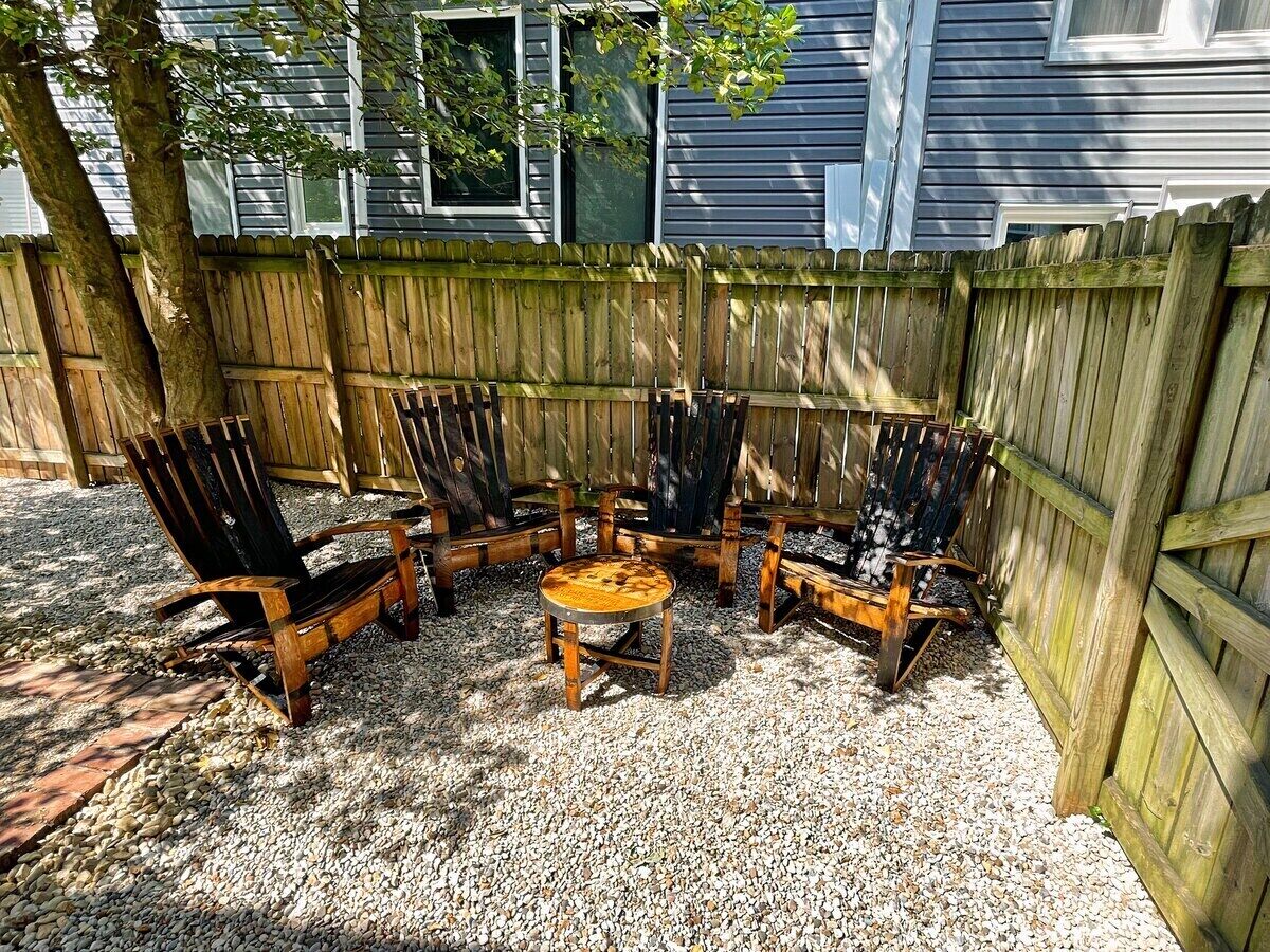 Sit back and relax on the pebble stone patio in our custom-made bourbon barrel Adirondack chairs. 