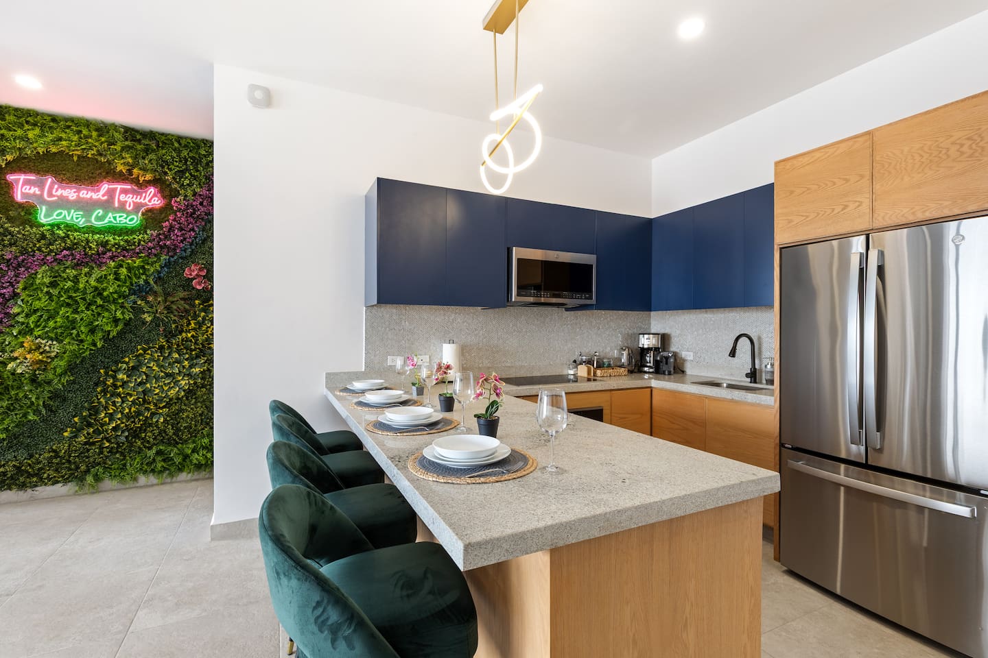 Granite countertops, stainless steel appliances, and bright lighting turn this kitchen into a perfect space to cook and connect.