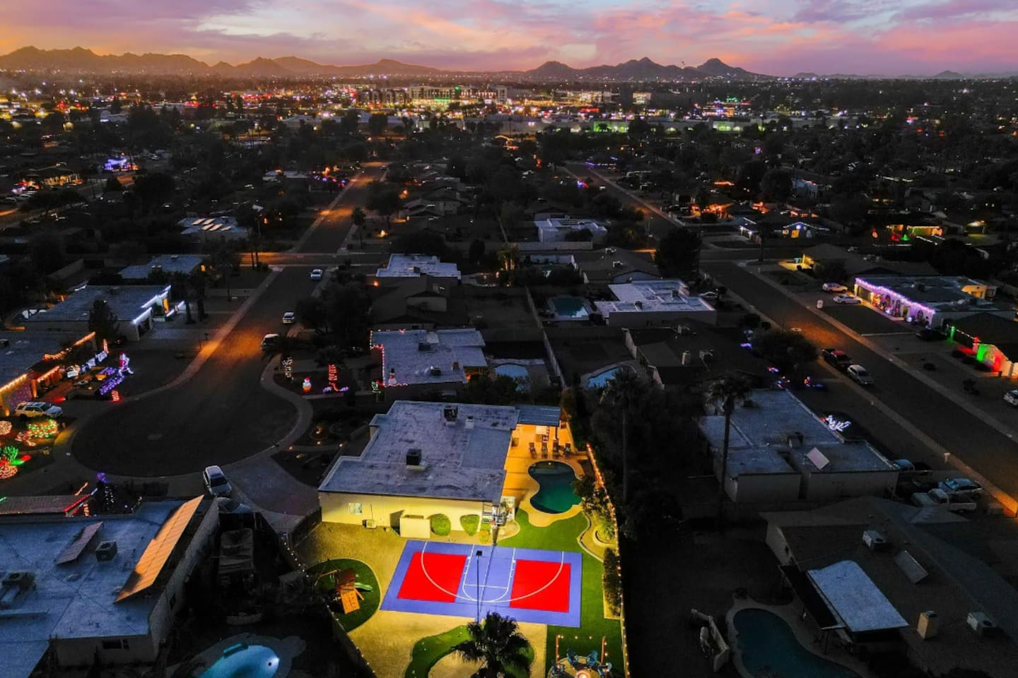 As the sky turns purple, the court lights take over — this backyard doesn't stop when the sun goes down.