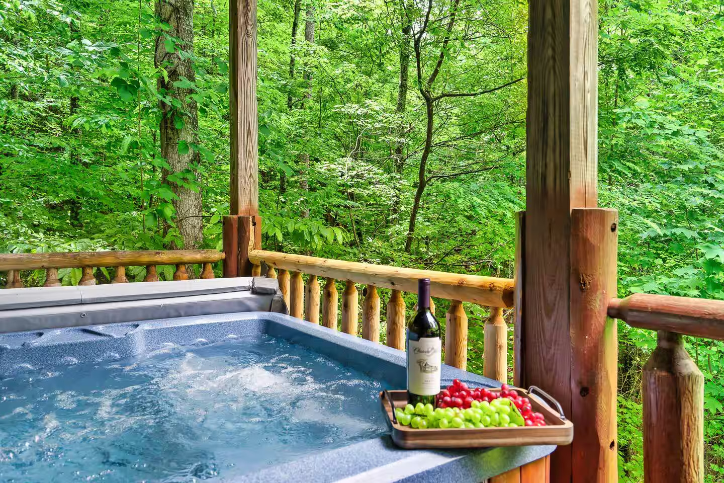 Enjoy this 6-7 seater hot tub, nestled on the upper deck, provides a serene retreat surrounded by warm wood tones and vibrant autumn leaves. It's the perfect spot to relax and soak in the tranquil forest and mountain views.