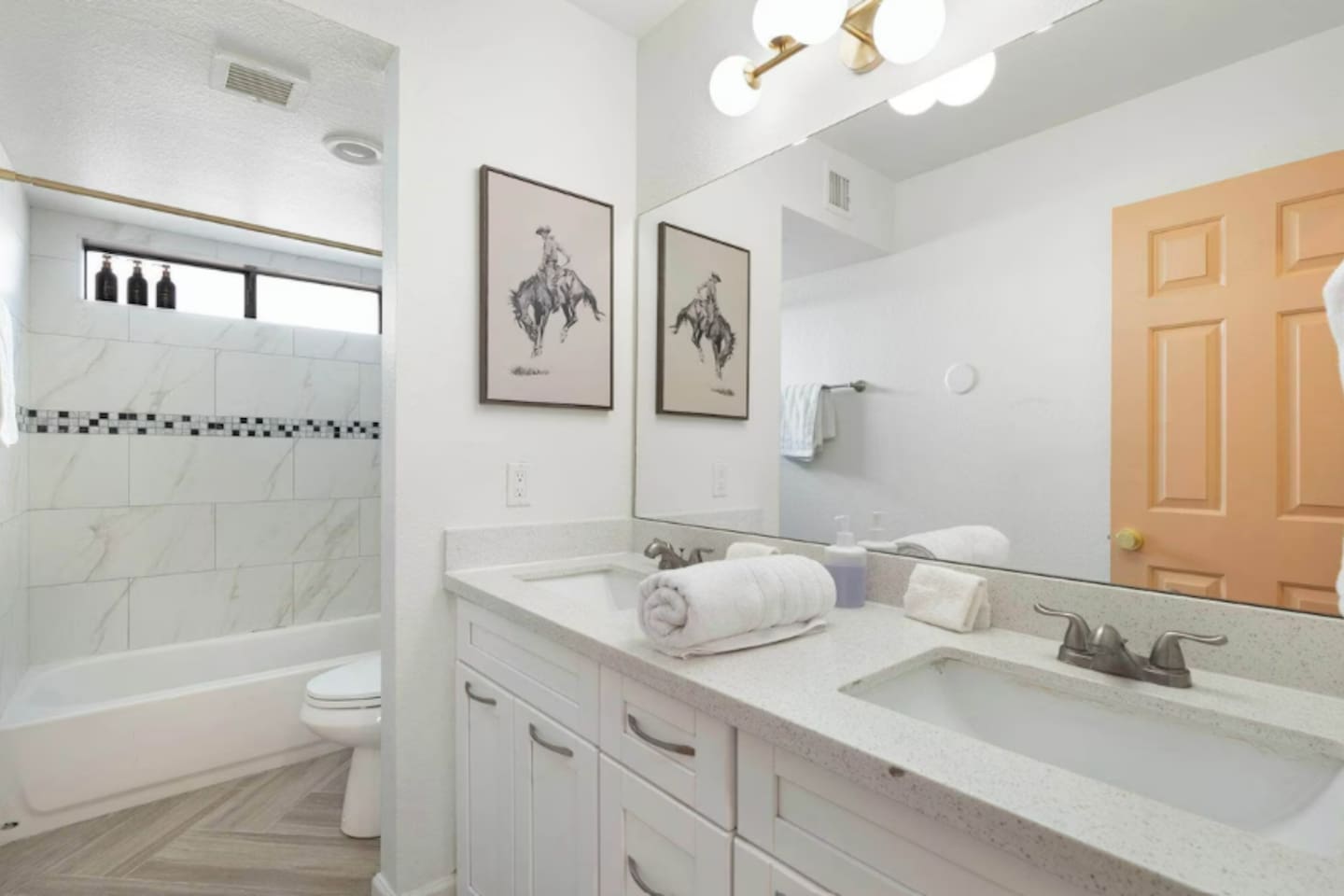 Custom tiled shower with tub and dual vanities.