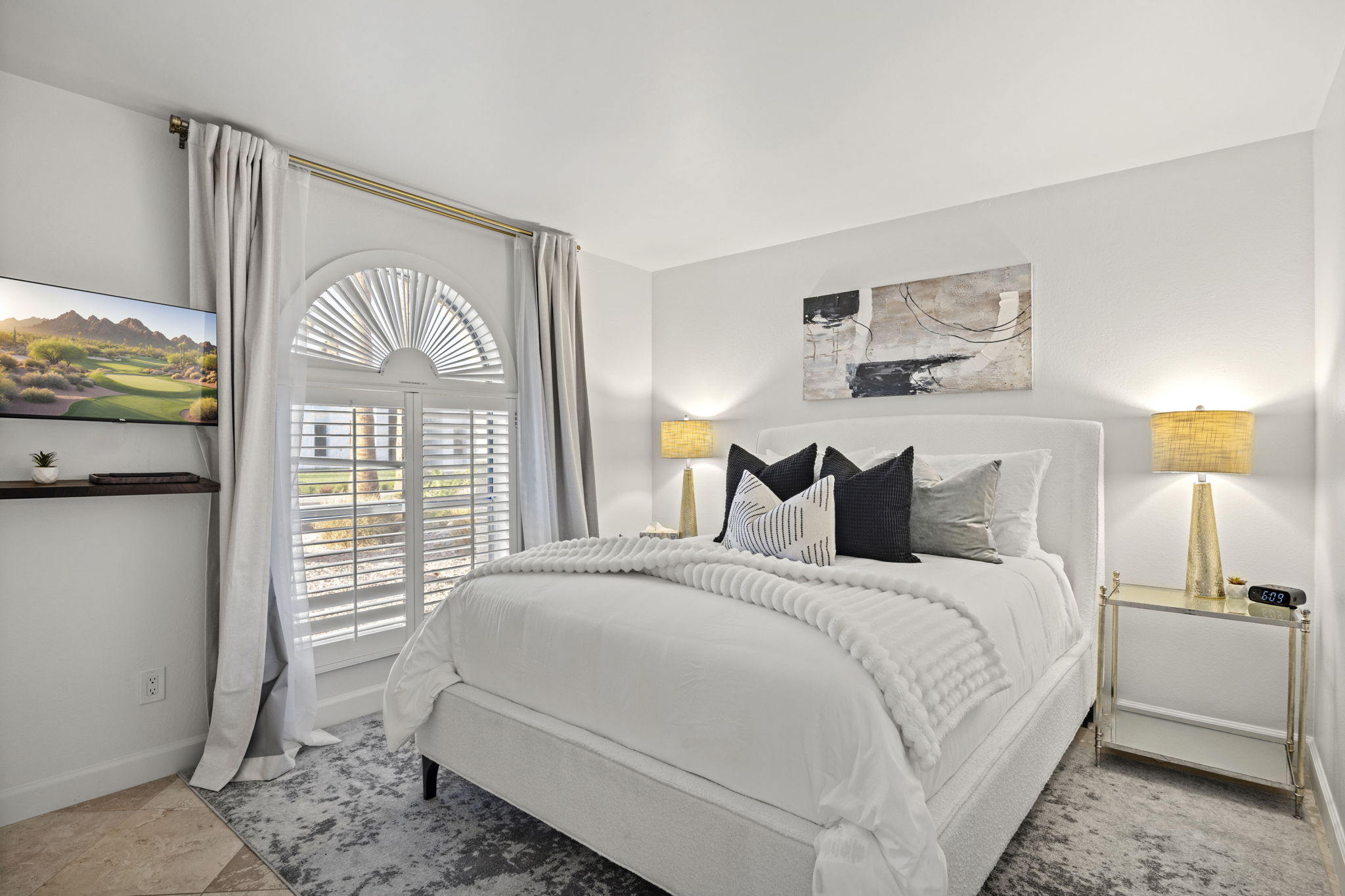 Guest bedroom with closet storage, full length mirror, flat screen TV and comfortable sleeping setup