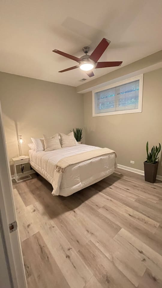 Bright comfortable bedroom designed for restful sleep after busy Chicago days