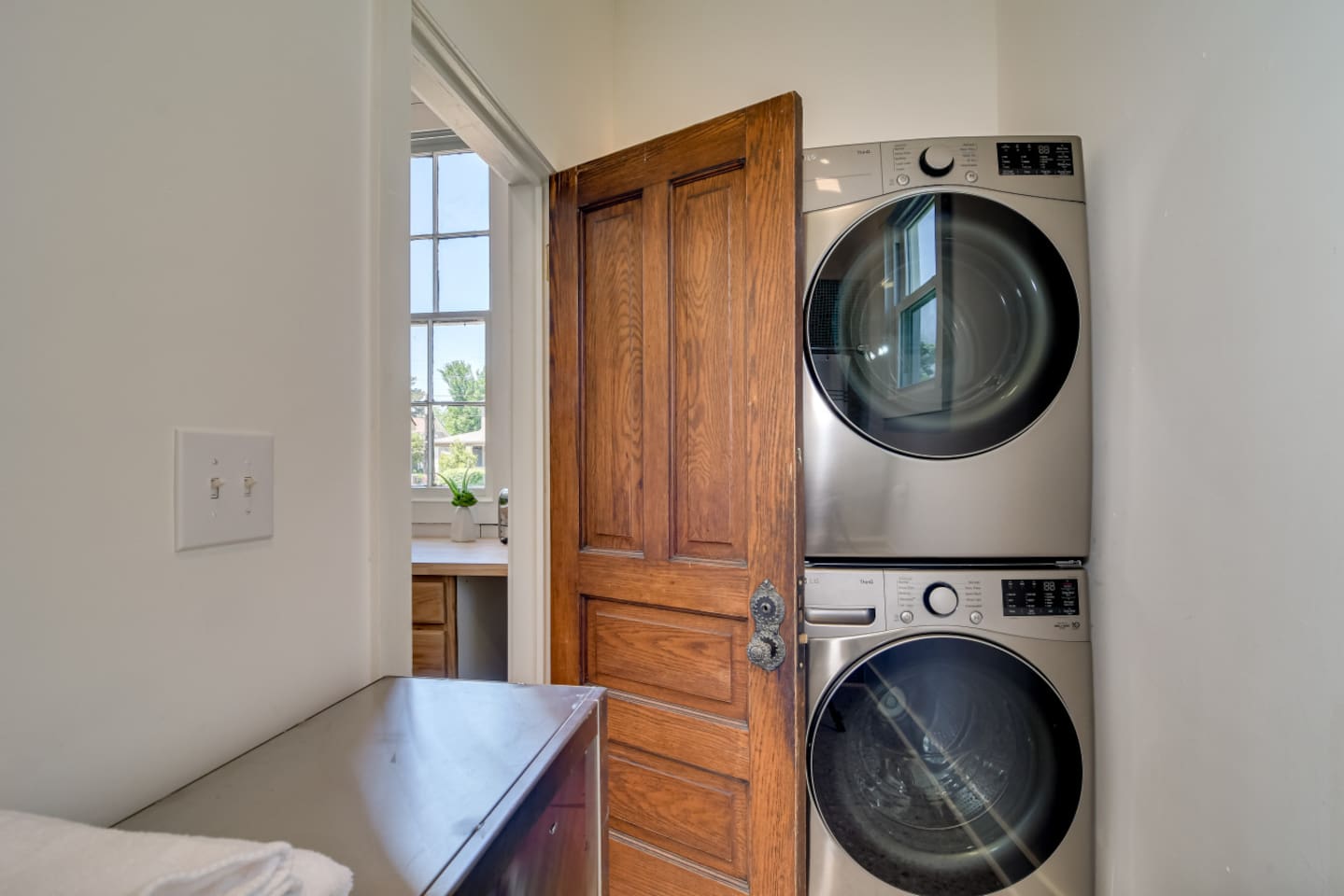 Full laundry room with stacked washer and dryer.