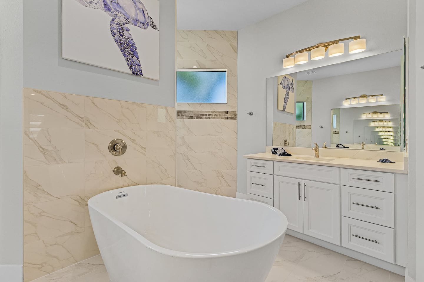 Indulge in the primary ensuite bathroom, complete with a relaxing tub for a soothing soak after a day of adventure!