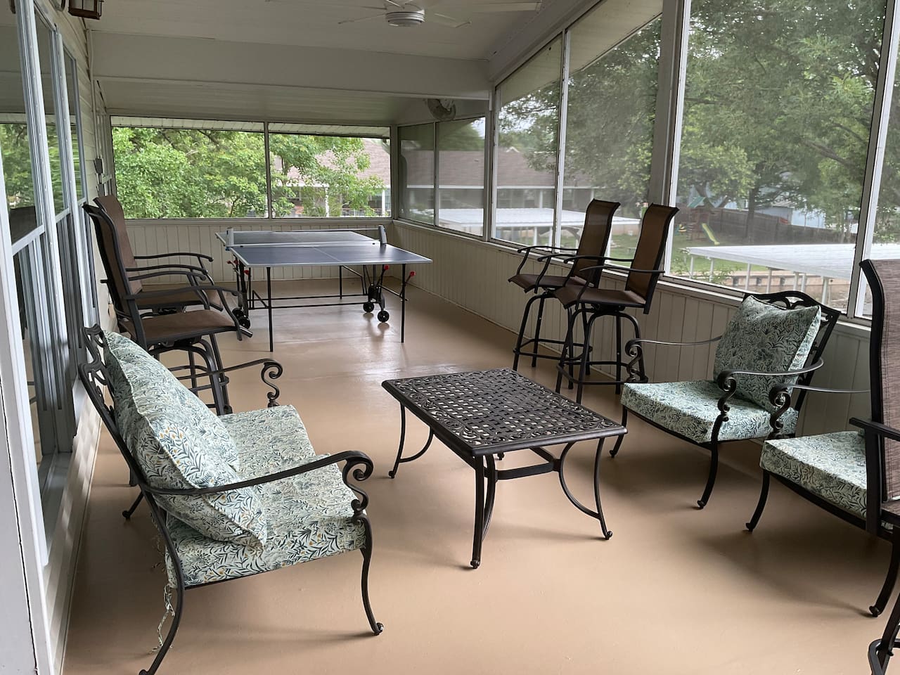 Ping pong and seating on upstairs screened in porch