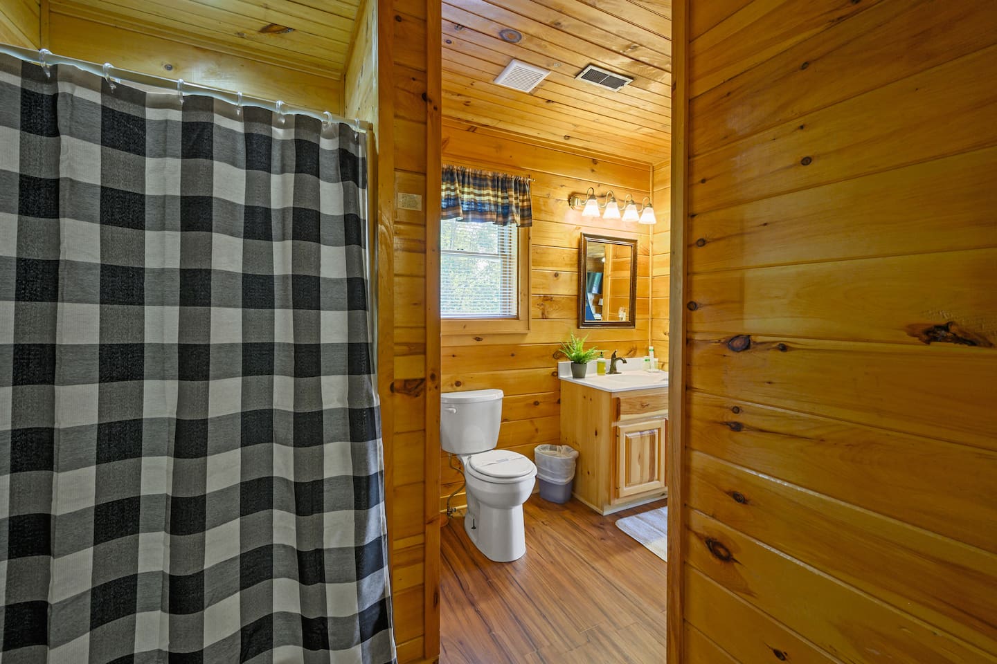 Shared bathroom on the lower level with oversized shower stall, toilet and vanity. 