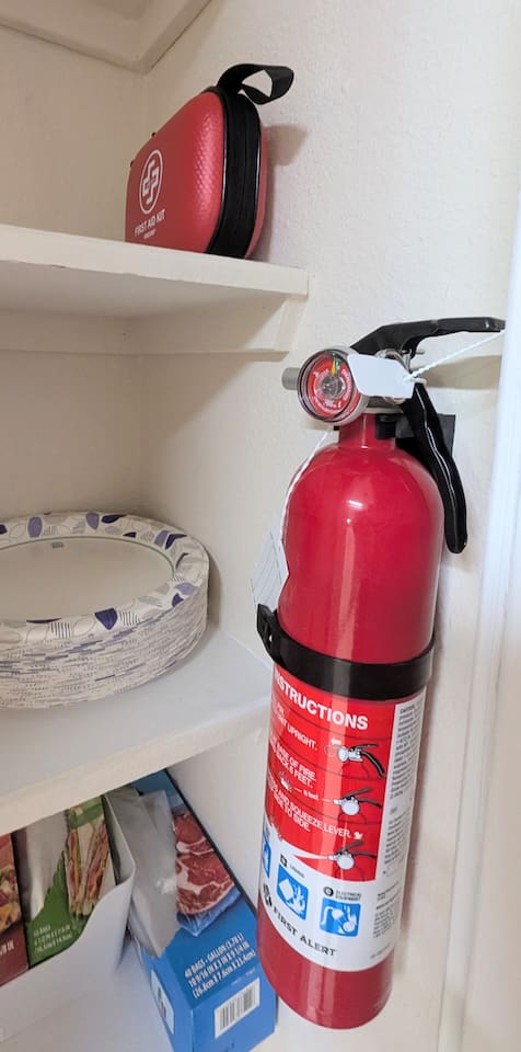 Fire extinguisher and first aid kit are conveniently located in the pantry. 