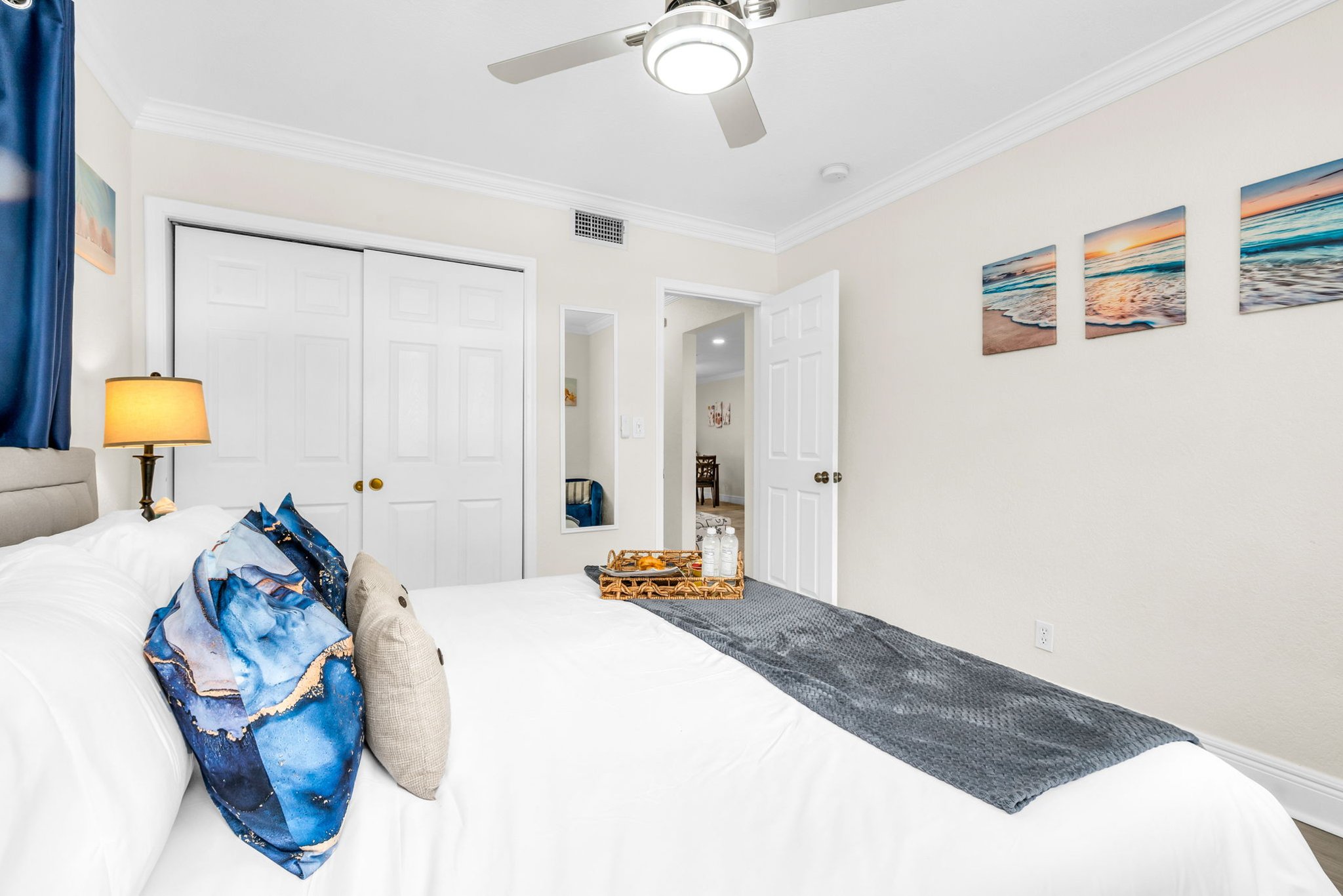 Unwind in the serene primary suite with a king bed, soft linens, and sunlit windows—your peaceful escape after a day at the beach.