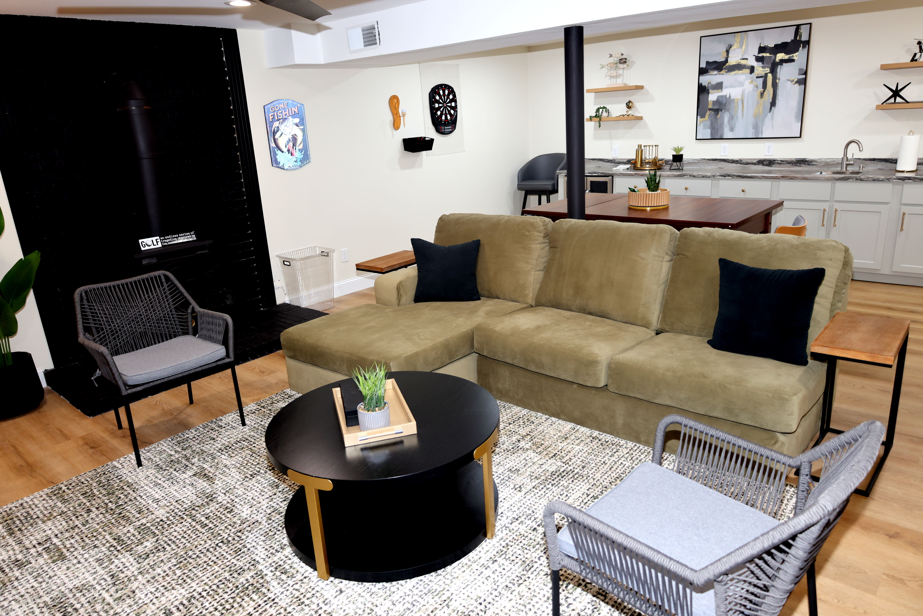 Comfortable lower-level lounge with seating, game table, wet bar, and entertainment space
