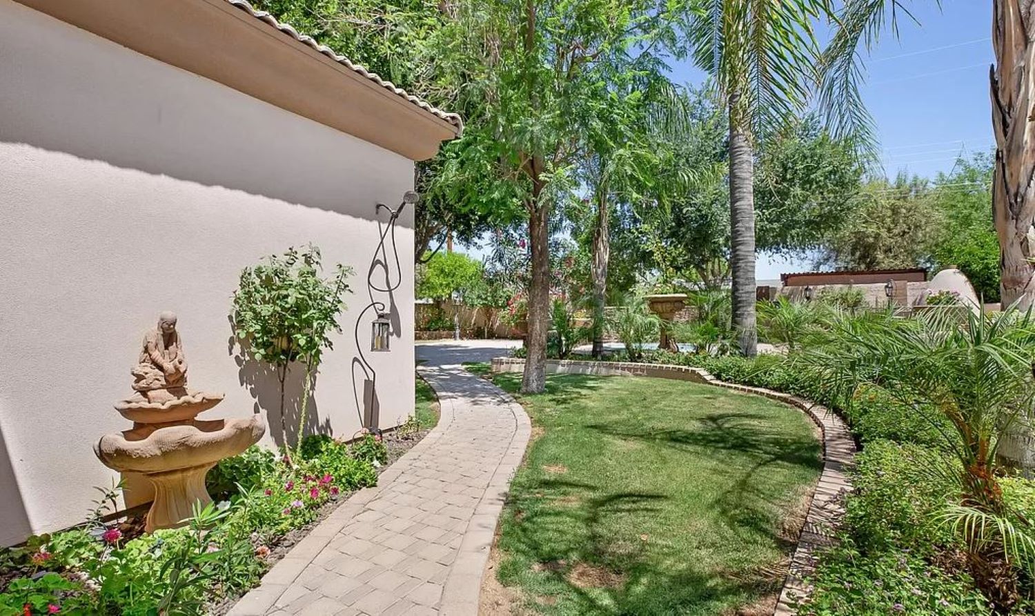 Stroll through this tranquil garden path framed by tropical greenery and desert charm, the perfect start to your peaceful escape.