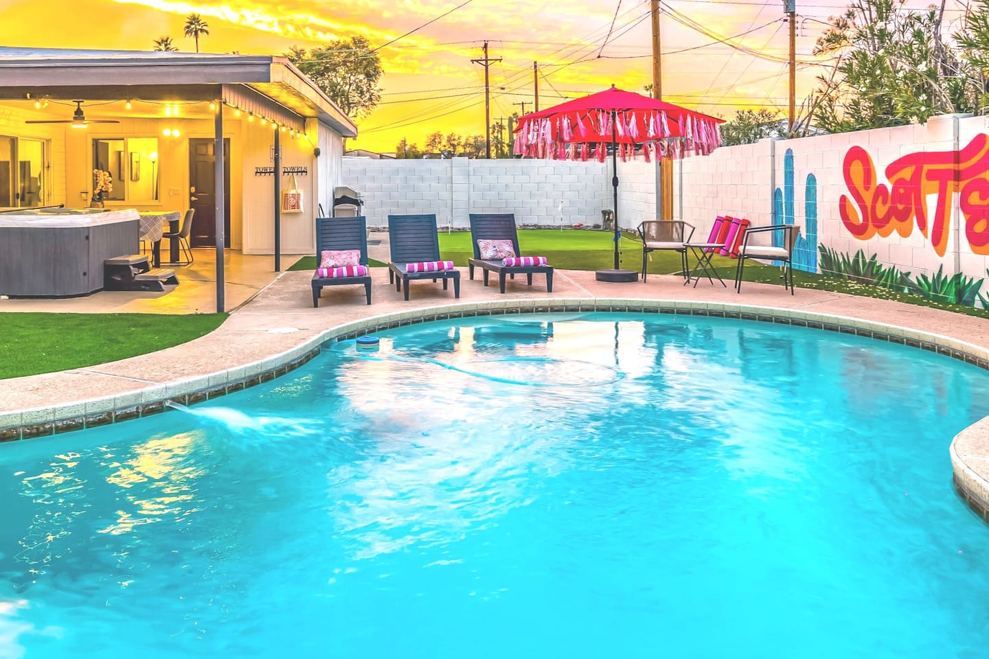 Bask in the glow of an Arizona sunset while enjoying your pool, cozy loungers, and vibrant desert art.


