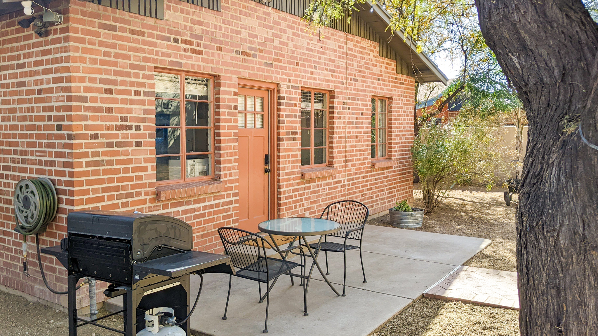 Exterior view, entrance, patio, outside dining area and grill