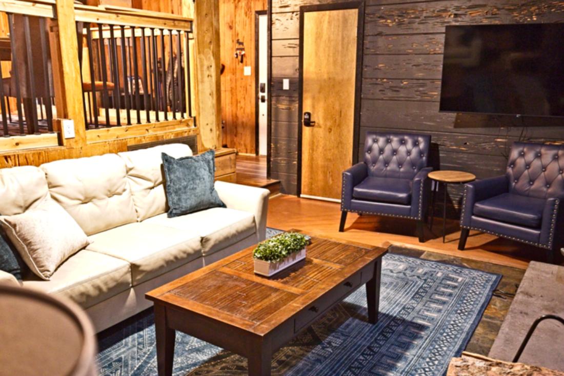 Kick back in your inviting living room, complete with a stone wood-burning fireplace, plush seating, bold leather chairs, and a Roku smart TV—perfect for movie nights, the big game, or relaxing after mountain adventures.